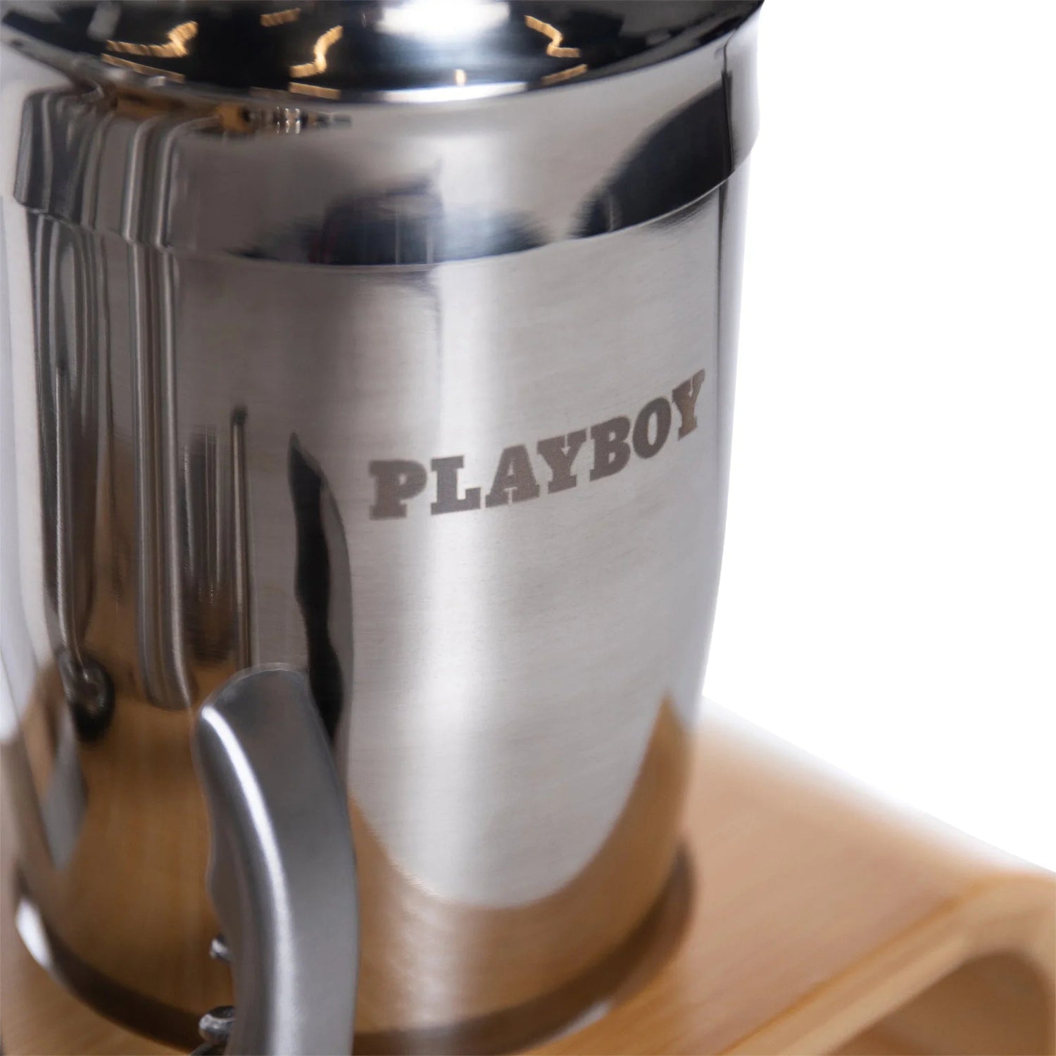 Stainless steel cocktail shaker with PLAYBOY text engraving on a wooden stand, barware accessory
