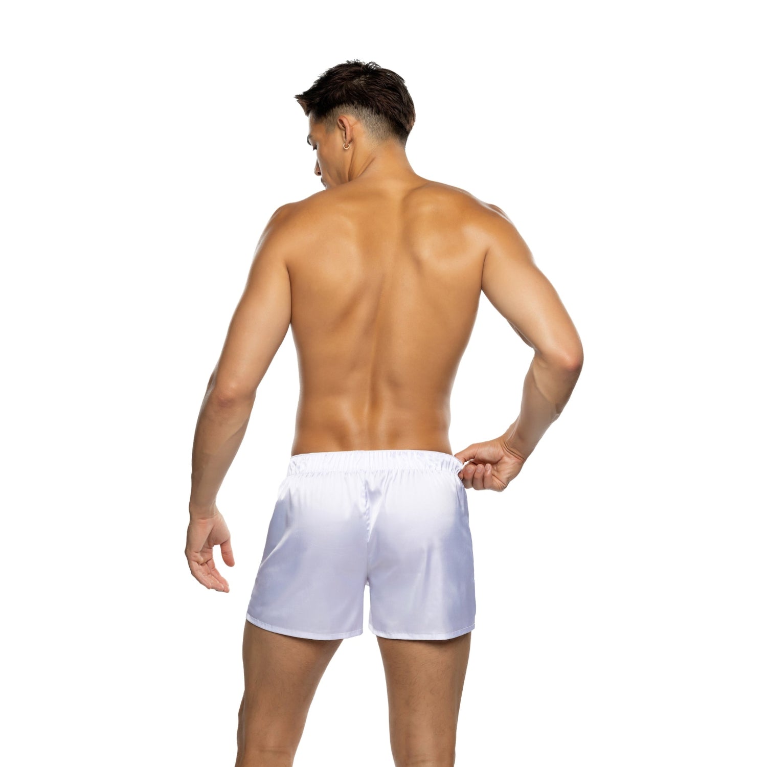 Shirtless male model wearing white satin boxer shorts, viewed from the back on white background