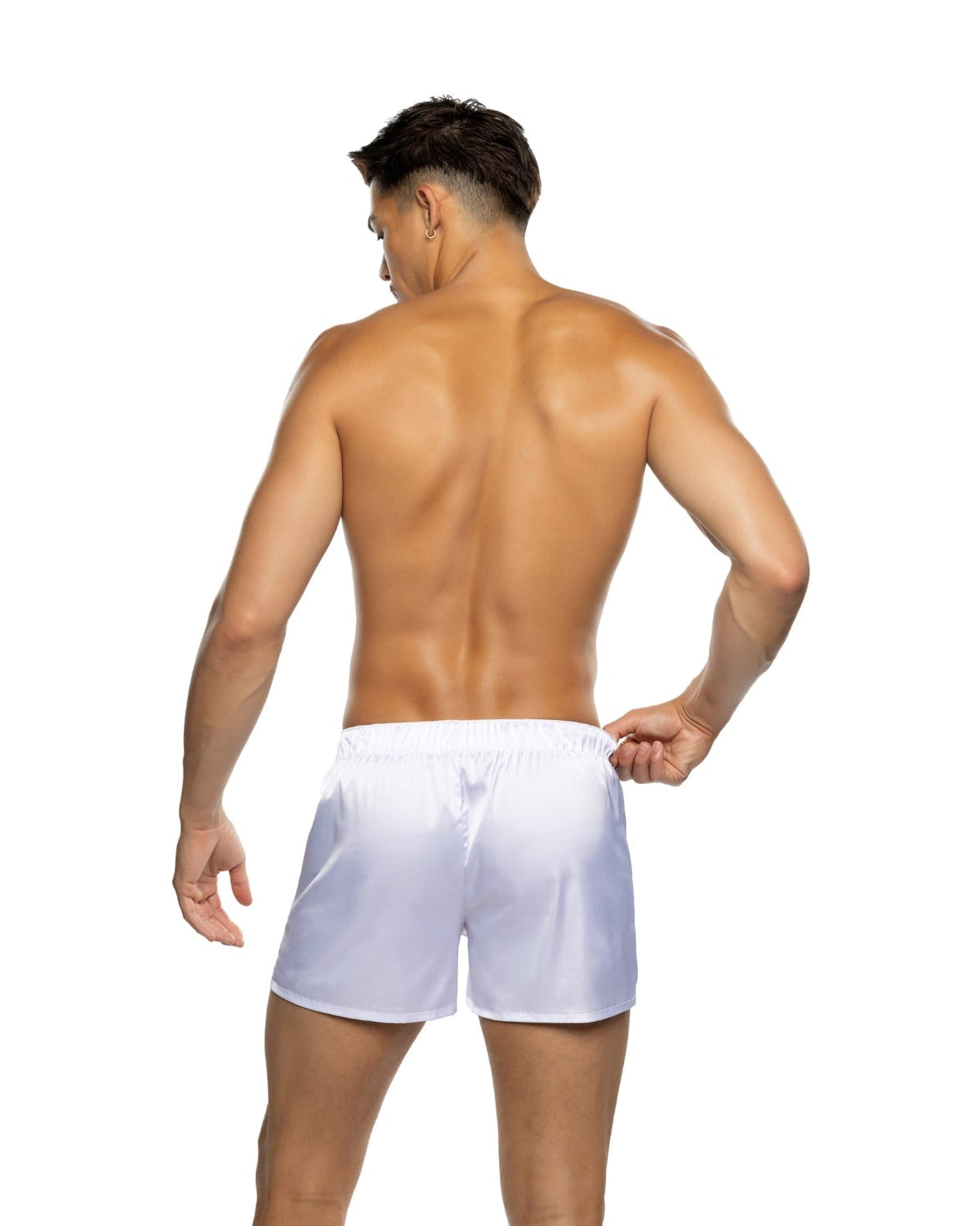 Shirtless male model wearing white satin boxer shorts, viewed from the back on white background