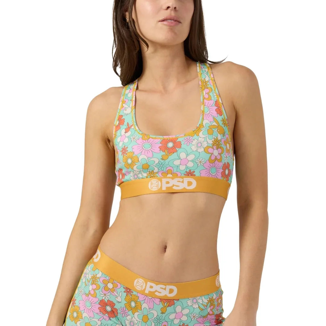 Woman wearing floral sports bra and shorts set with yellow PSD waistband