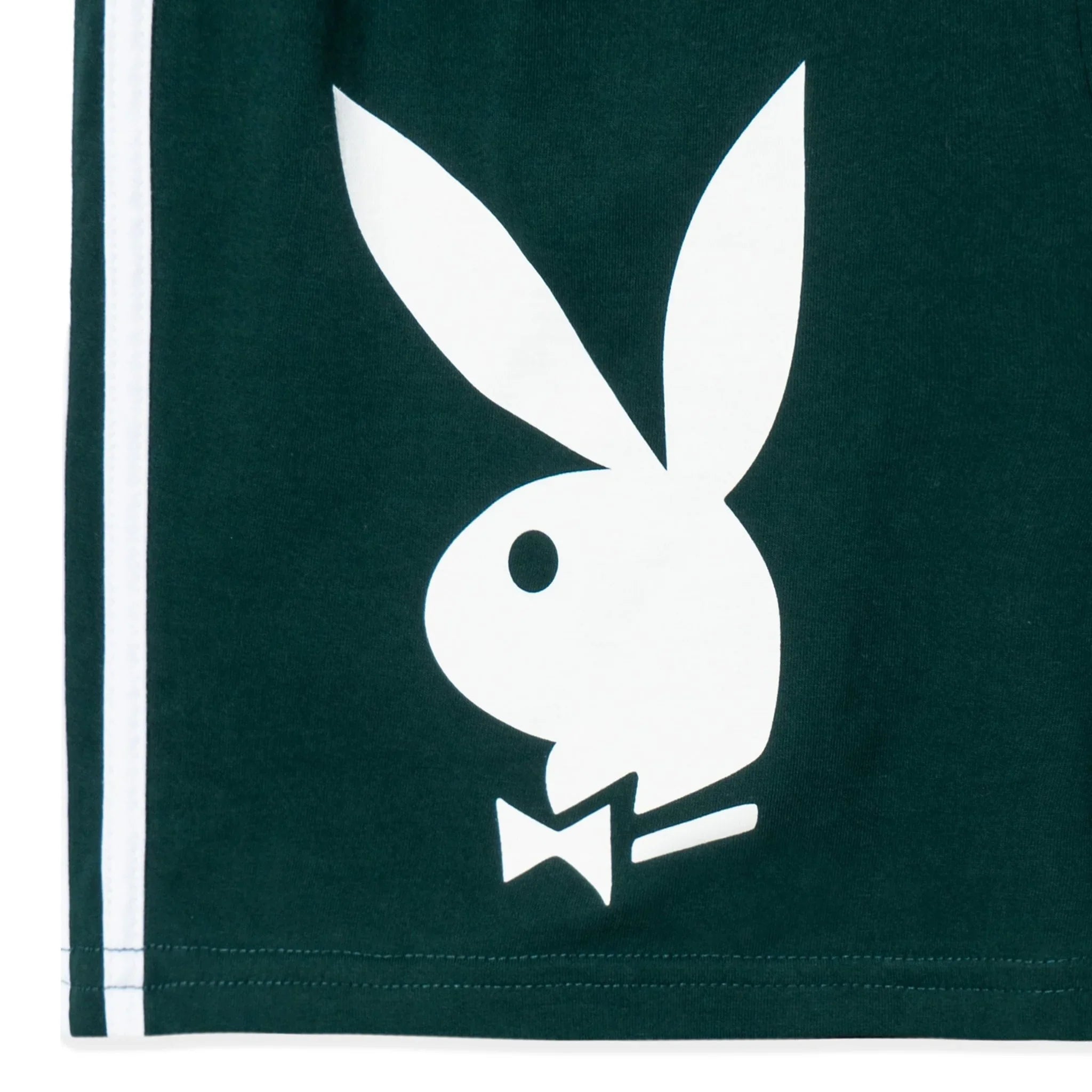 Green sport shorts with white bunny logo and side stripes, close-up detail view