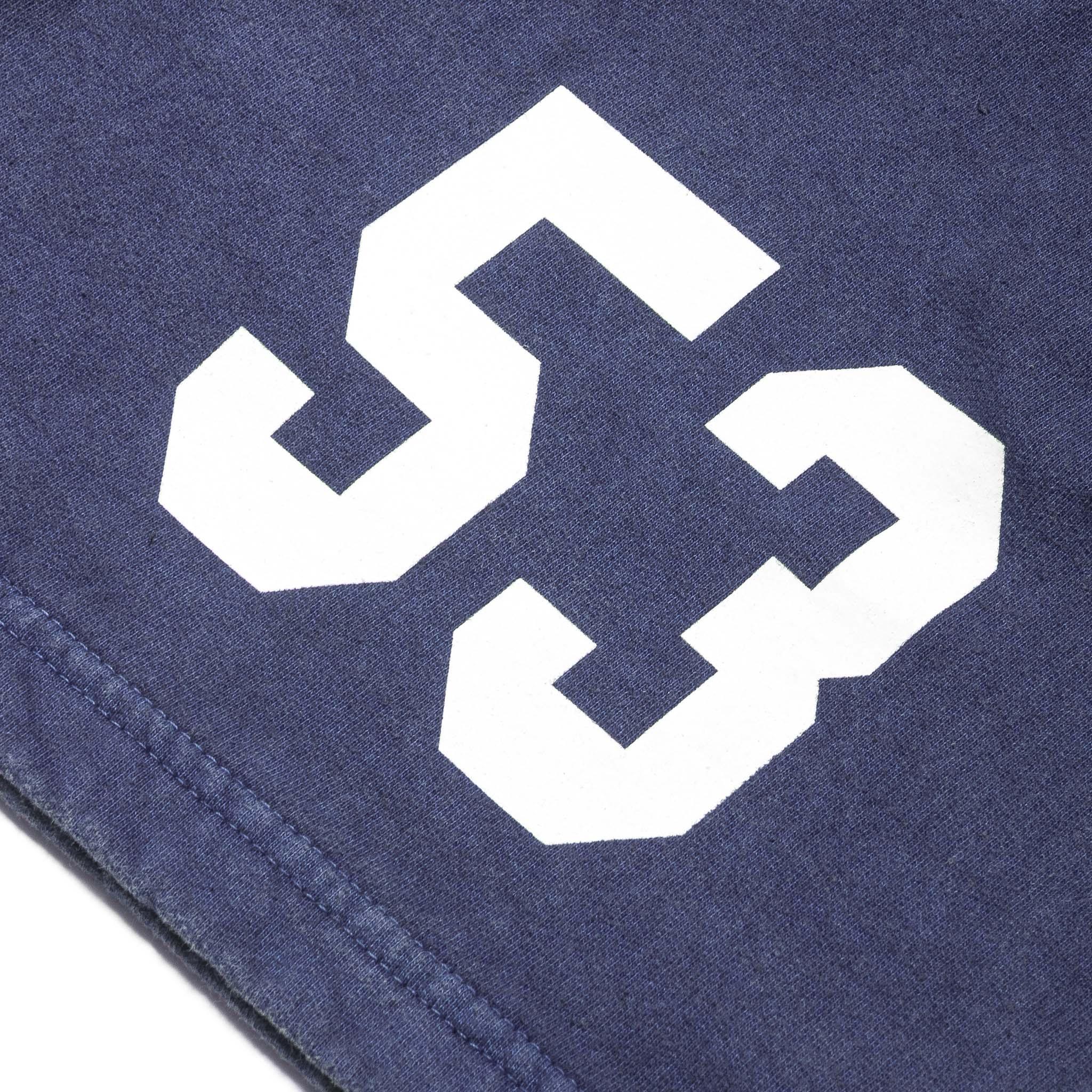 Close-up of blue sweatshorts with bold white 53 graphic print