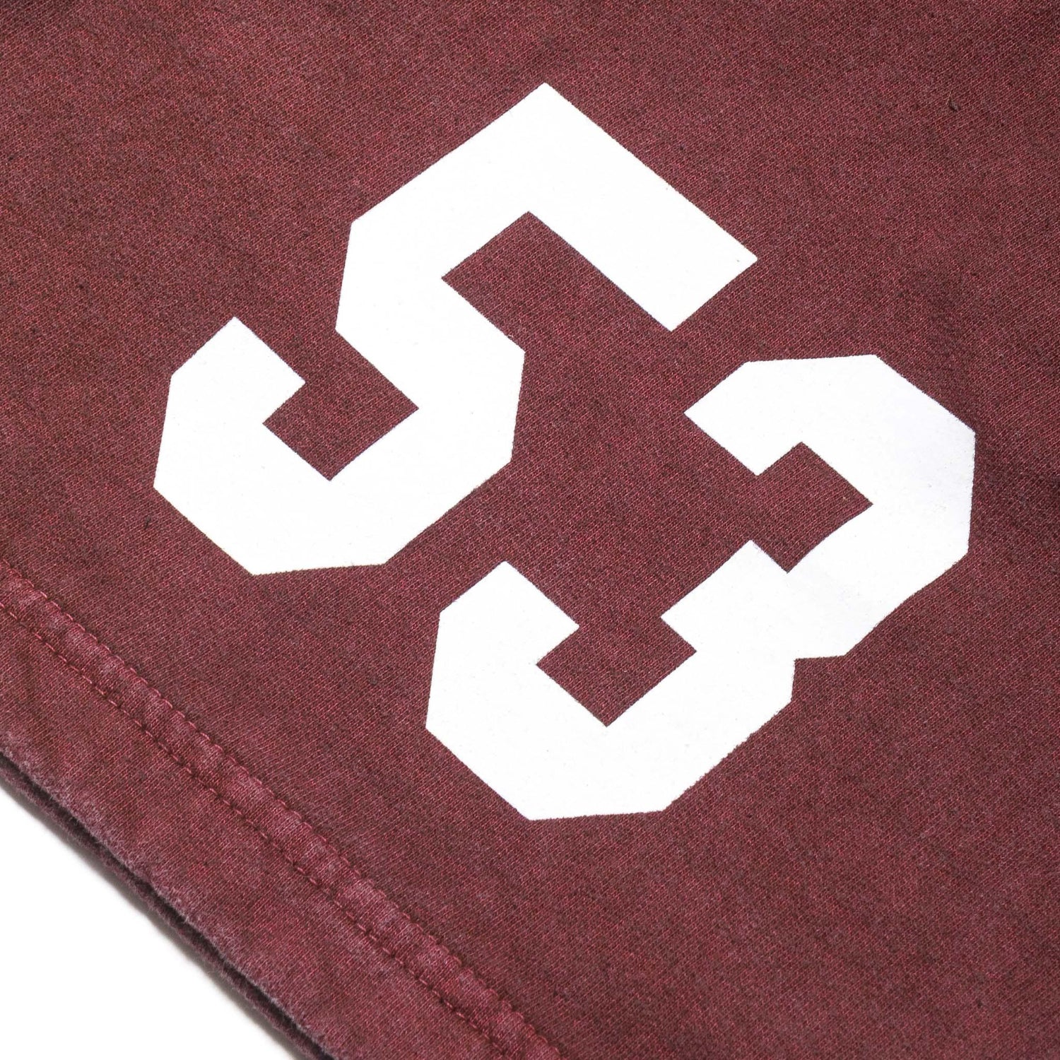 Close-up of maroon sweatshorts with bold white number 53 graphic print