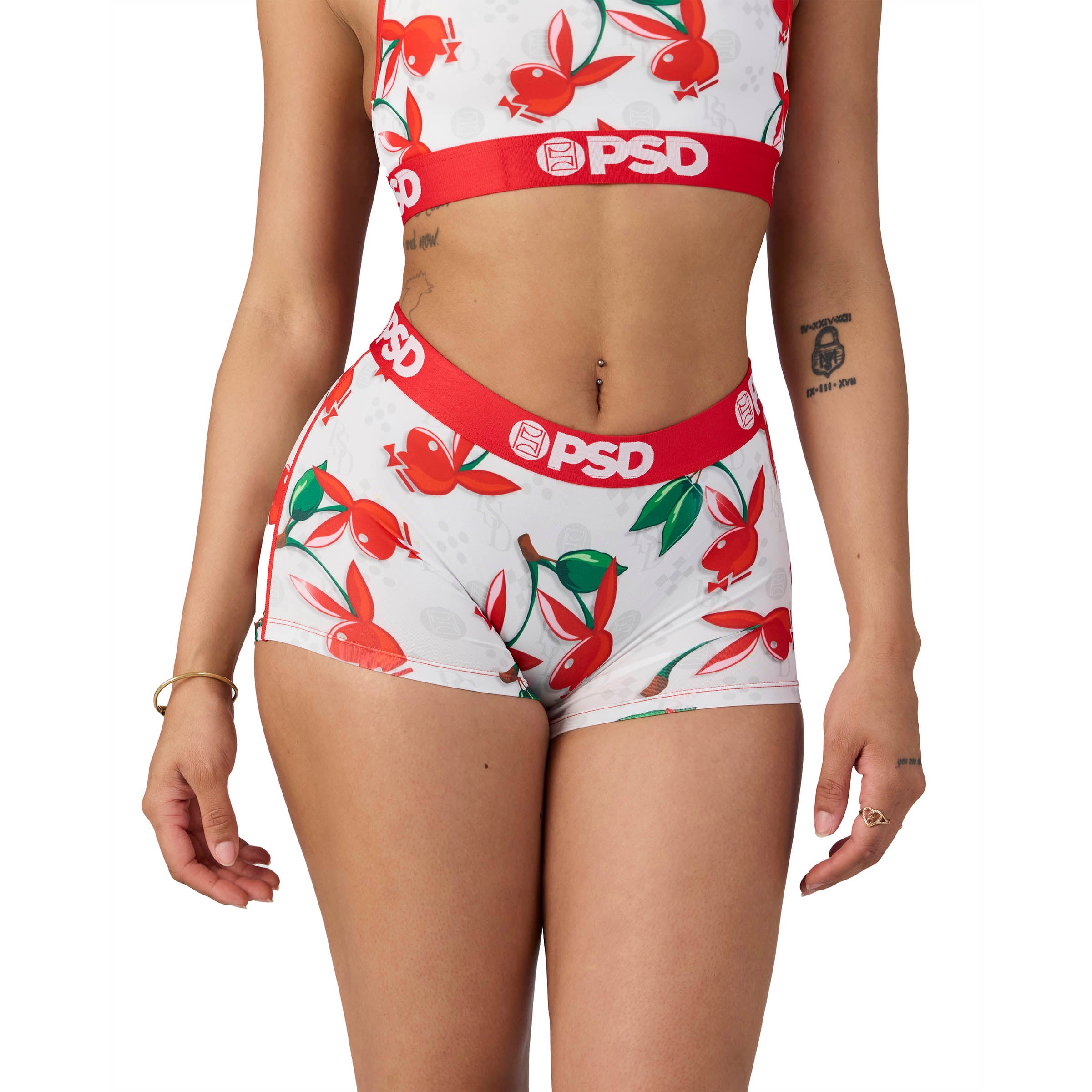 Woman wearing Playboy x PSD white shorts and crop top with red and green bunny cherry print