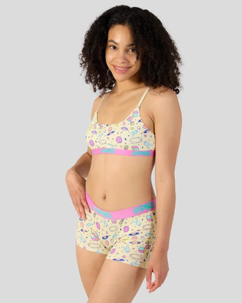 Woman wearing a colorful bikini set with a white background