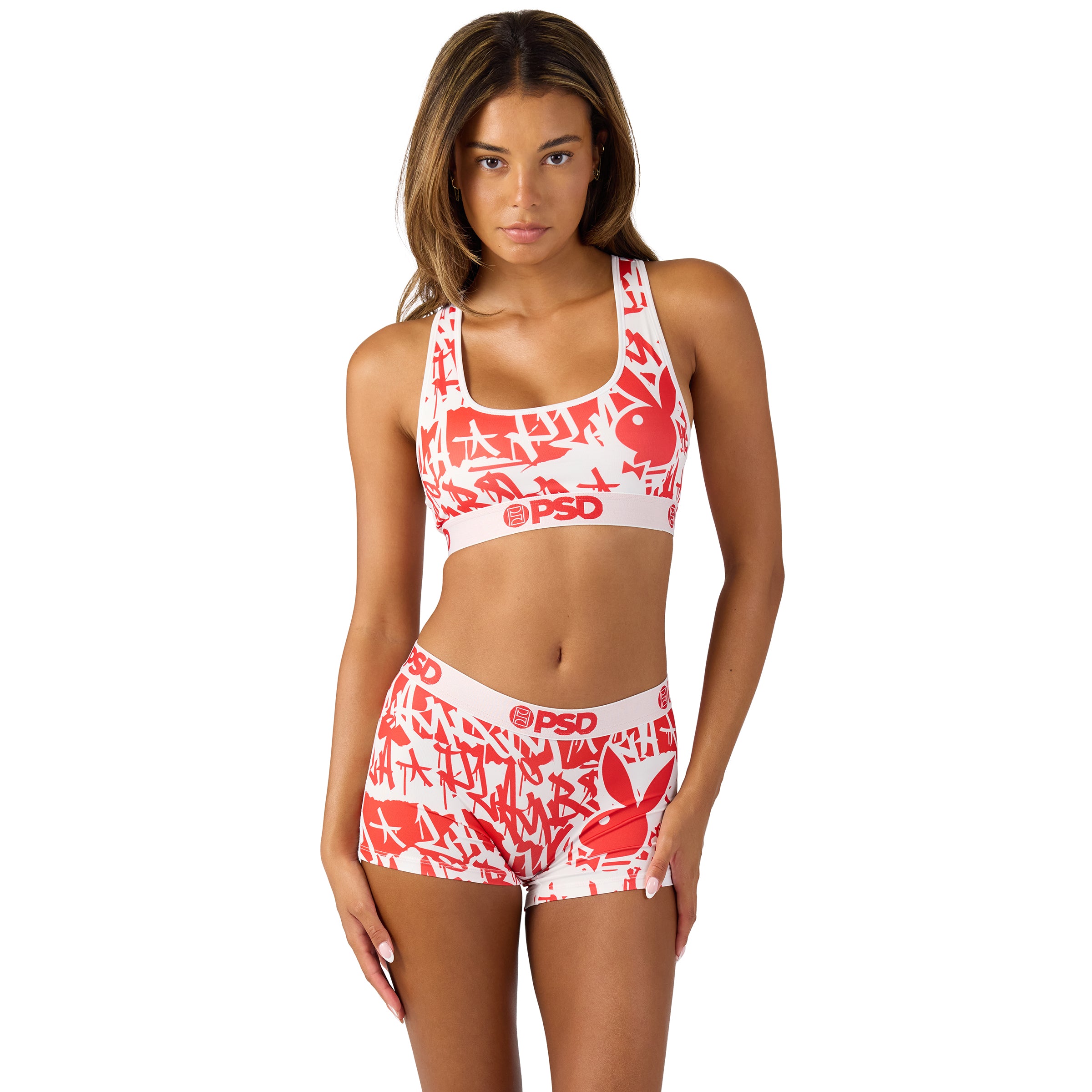 Woman modeling red and white Playboy logo sports bra and shorts set, official Playboy apparel