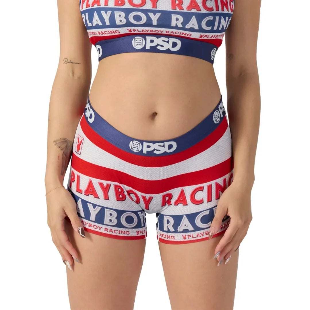 Woman wearing red, white, and blue Playboy Racing crop top and shorts set, PSD logo visible