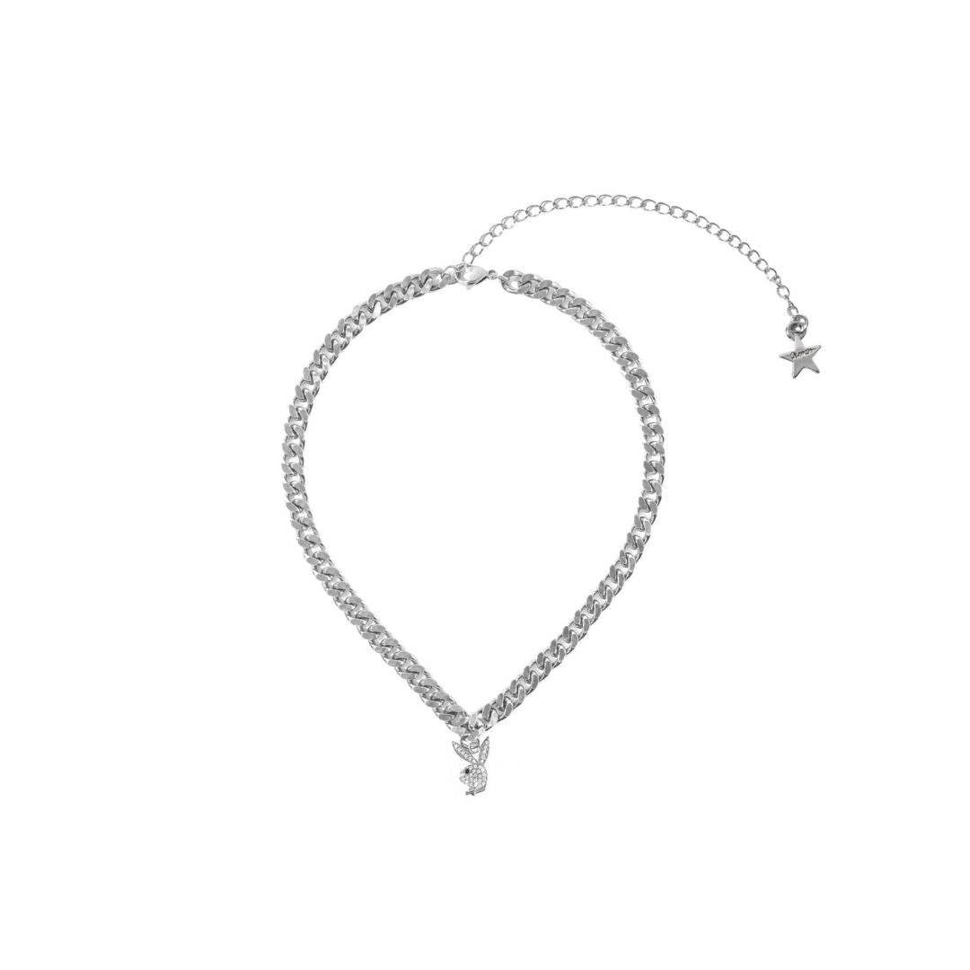 Silver chain necklace with pendant and star charm on white background