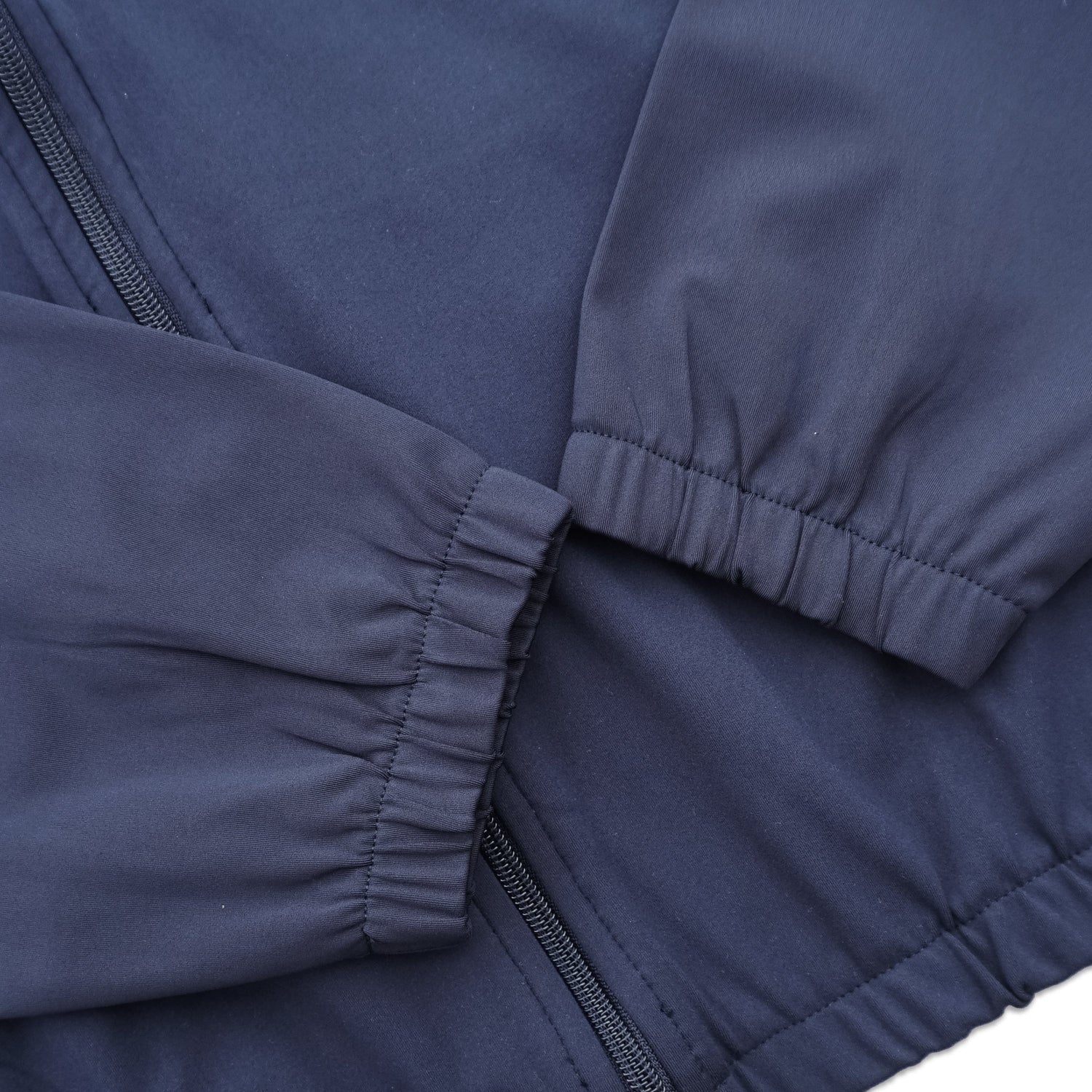 Close-up of a navy blue jacket with a focus on the fabric texture and stitching.