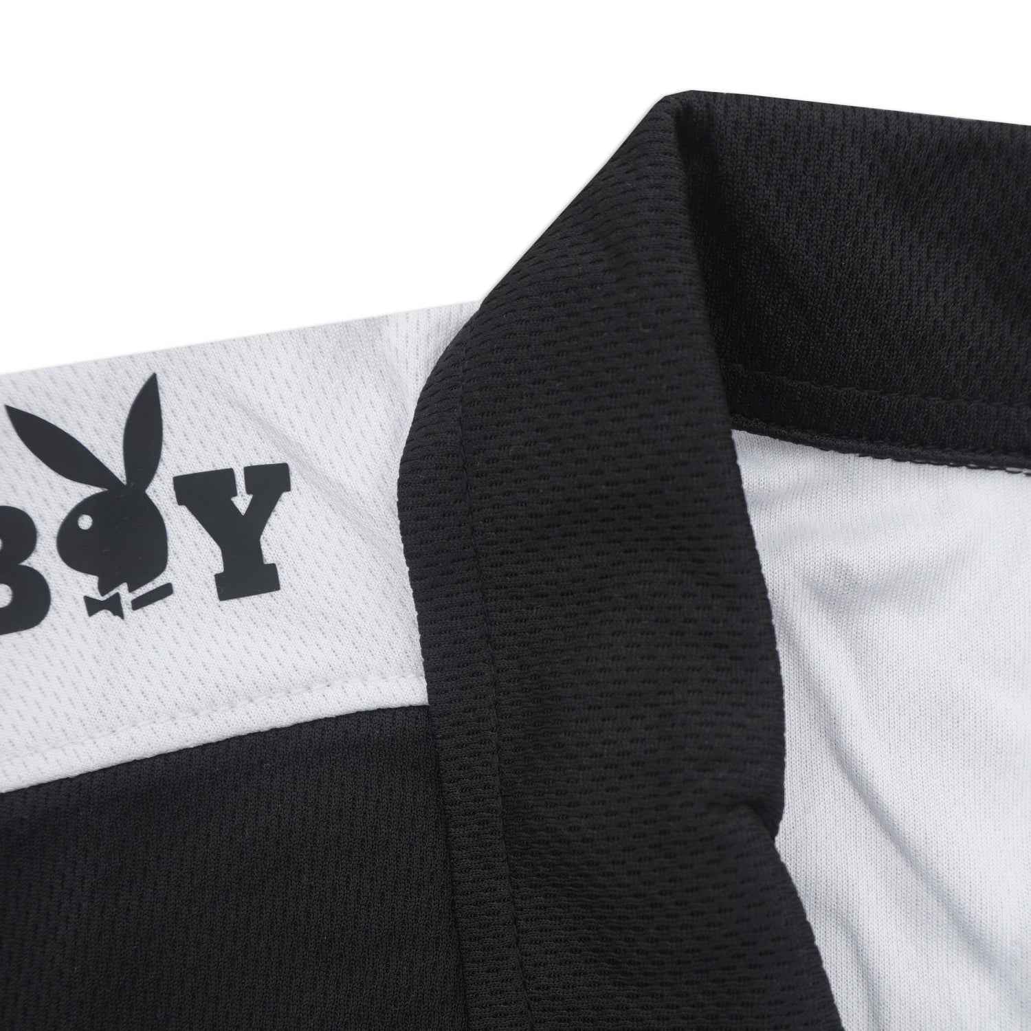 Close-up of a black and white shirt with Playboy logo on a white background