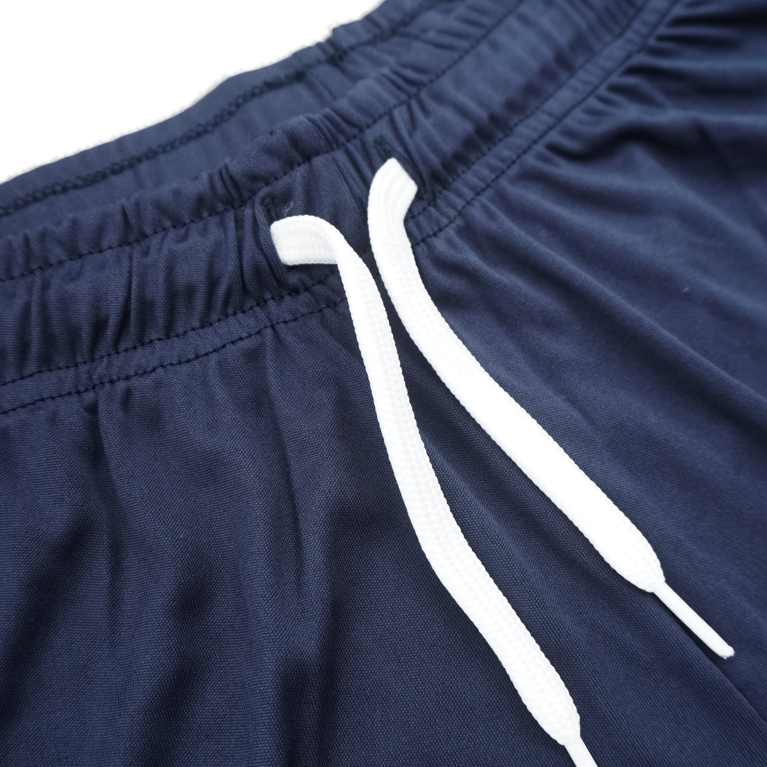 Navy blue shorts with white drawstrings on a white background