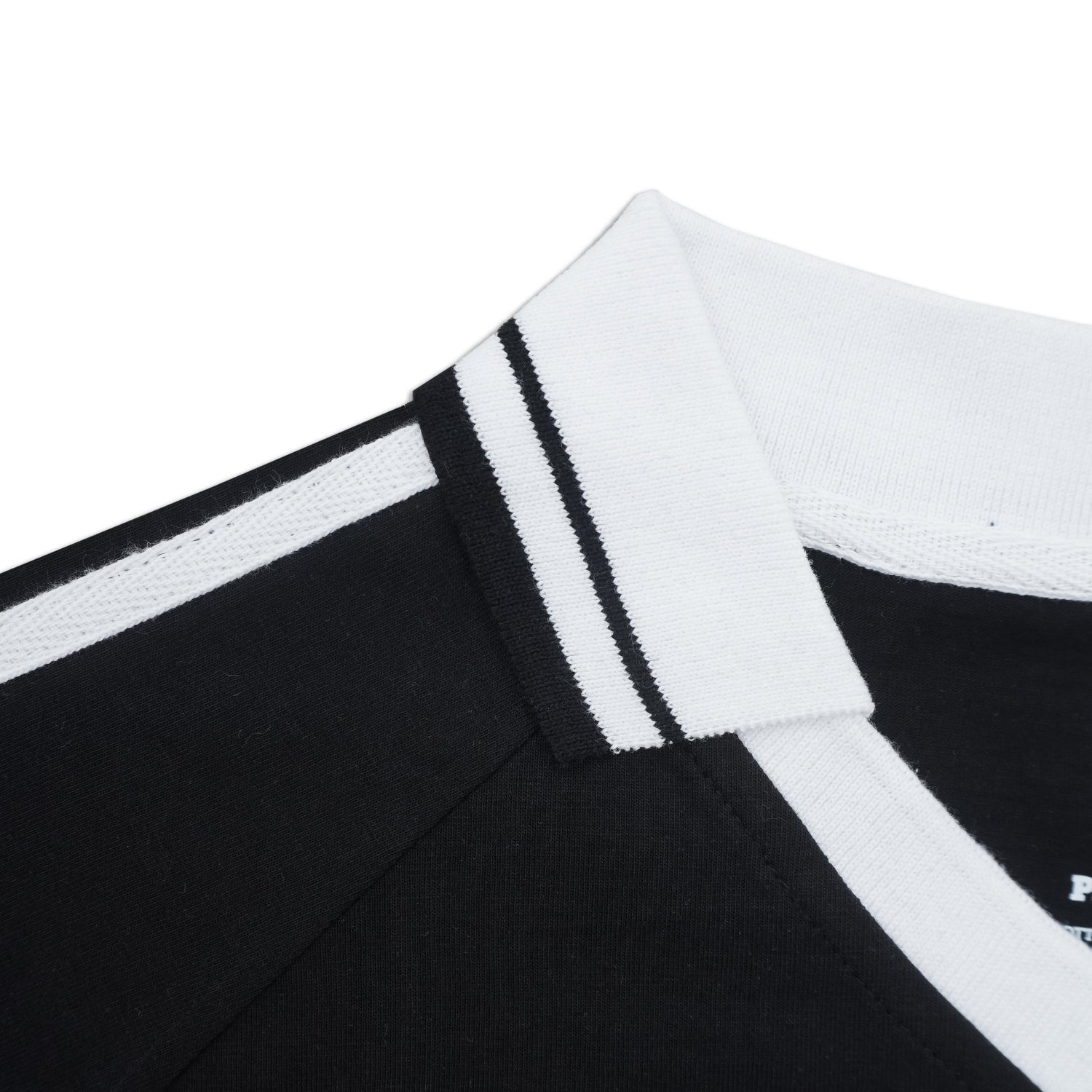 Close-up of a black and white striped garment with a brand logo.