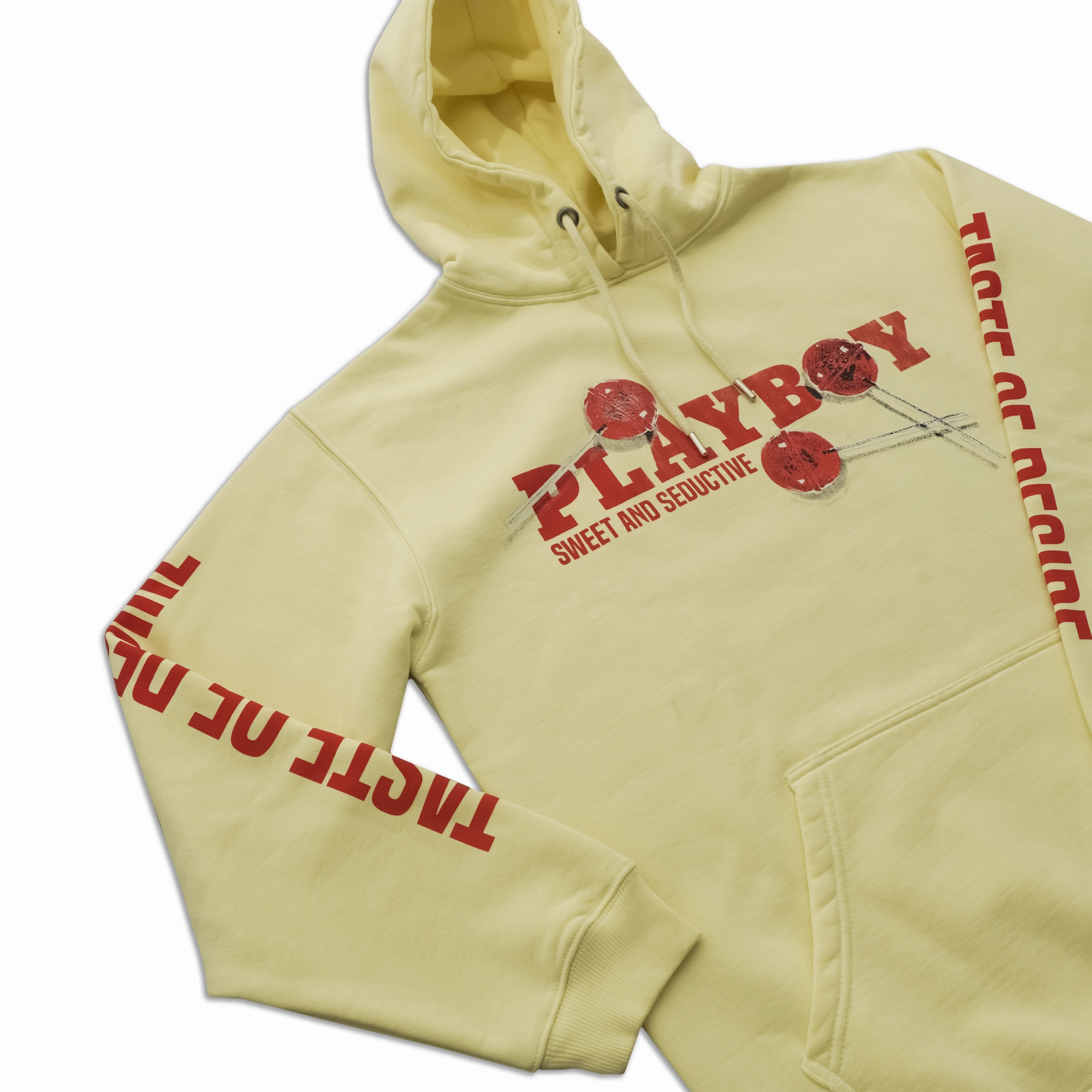 A pale yellow hoodie featuring red 'PLAYBOY' text with red-and-black eye graphics on the chest, plus 'TIGER OF ANCHOR' printed in red down both sleeves, shown on a white background.