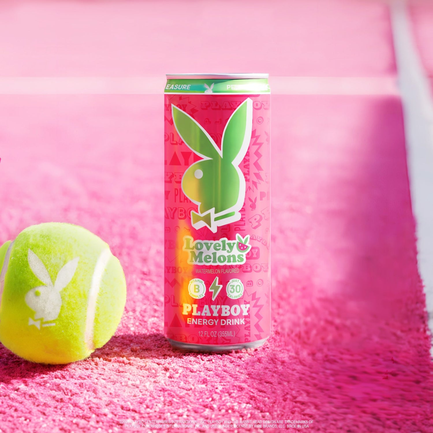 Playboy energy drink can with a tennis ball on a pink background