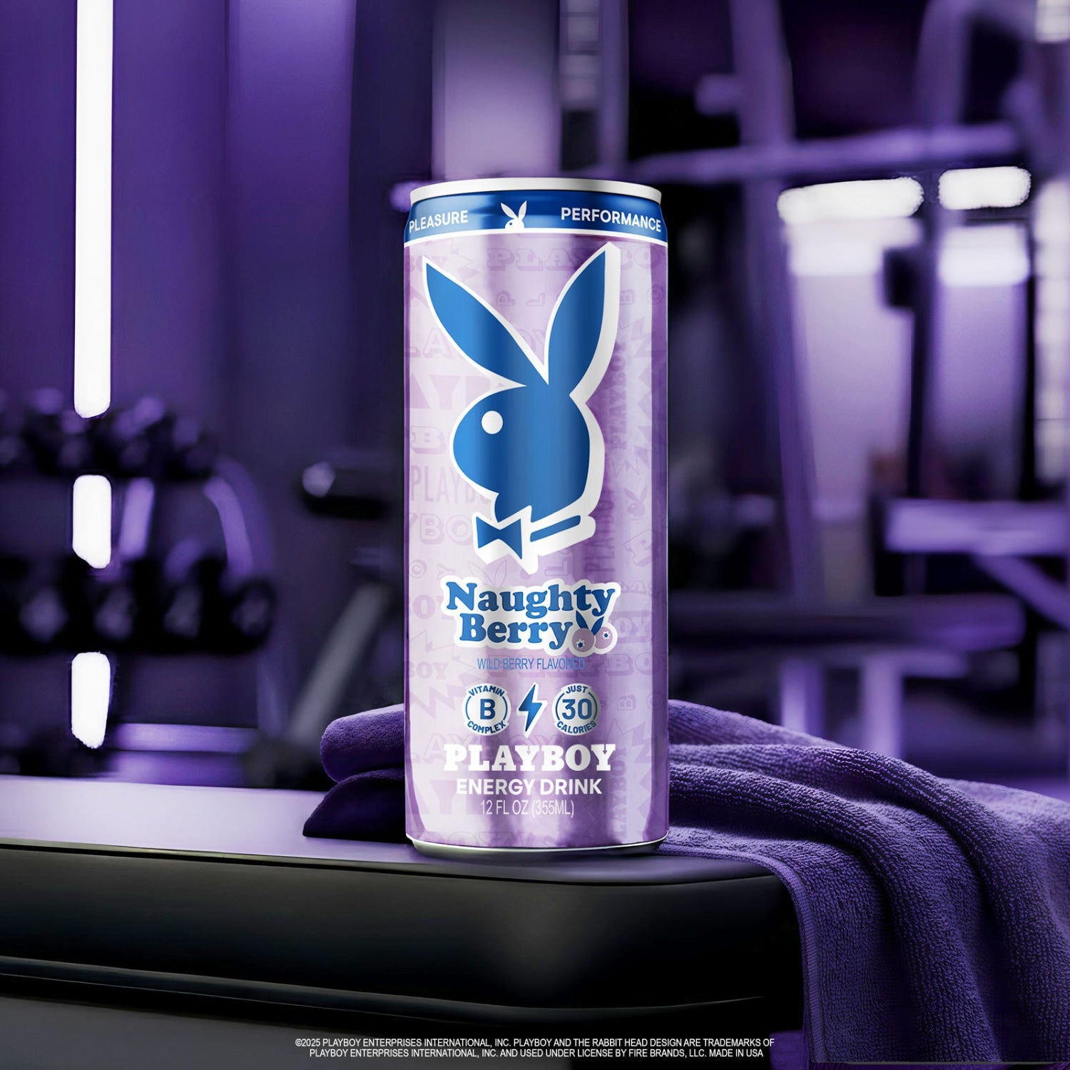 Playboy Naughty Berry energy drink can on a purple surface with a blurred gym background