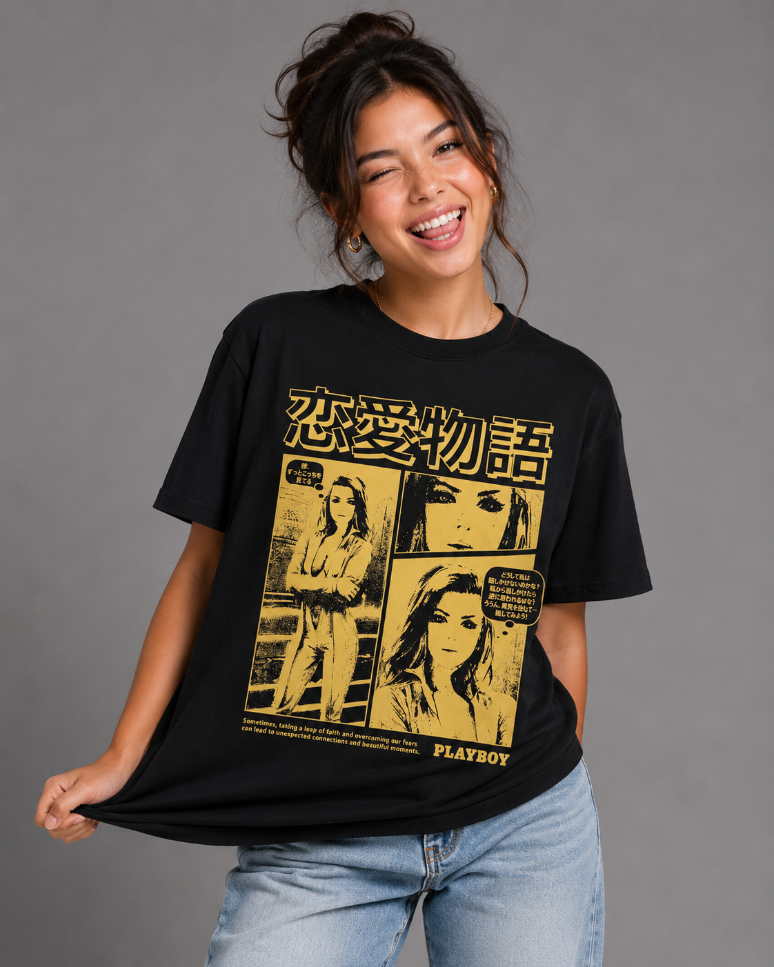 A woman wearing a black oversized graphic T-shirt with a yellow Japanese-style manga print and light blue jeans, posing against a solid gray studio background. #Women