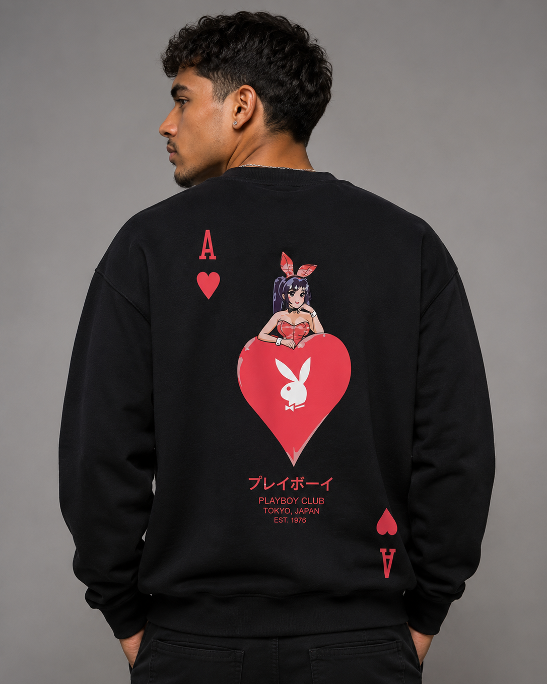 A man wearing a black sweatshirt, viewed from the back, featuring a large red and white graphic of an anime bunny girl on a heart with Playboy branding.