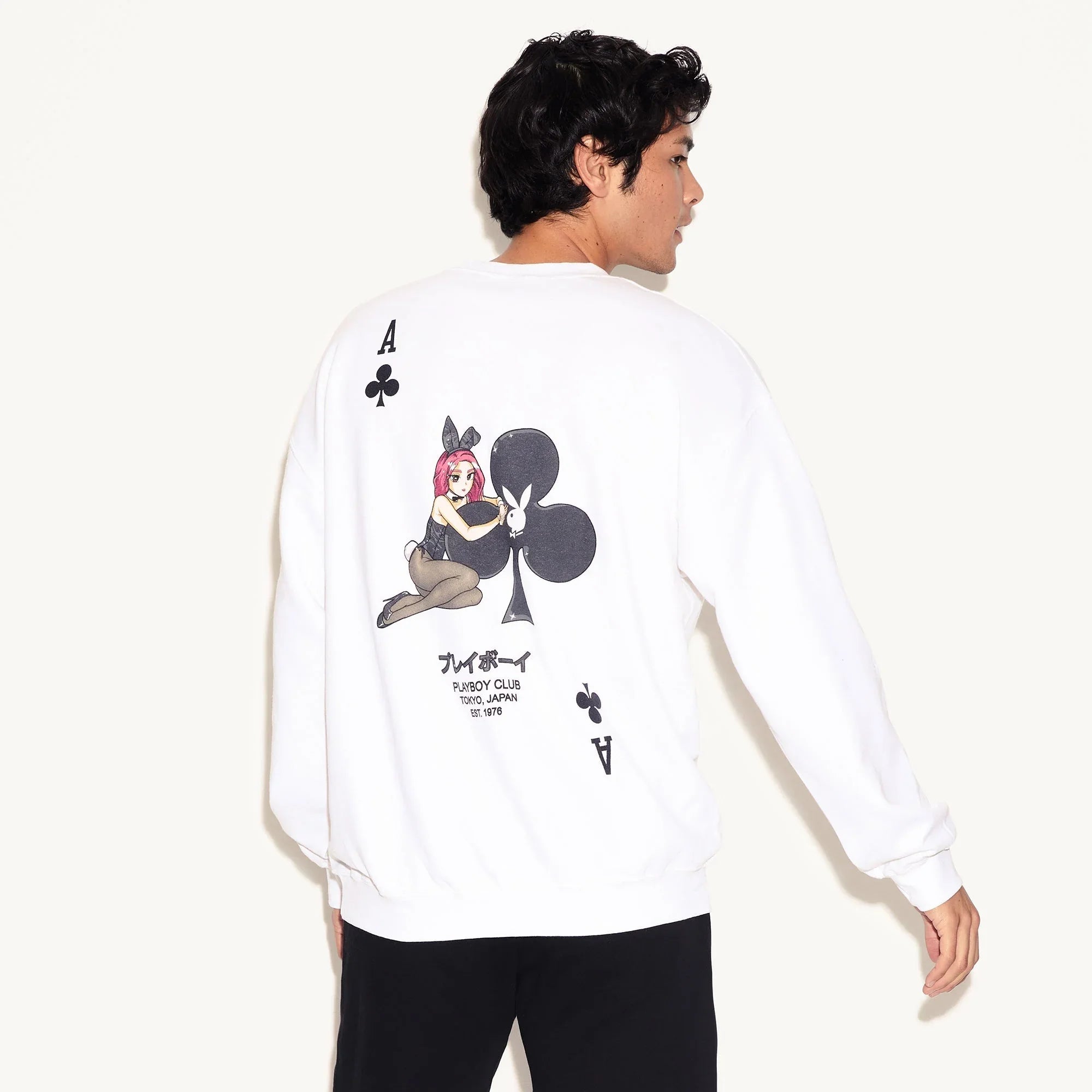 White crewneck sweatshirt featuring ace of clubs playing card and cartoon bunny girl graphic on back