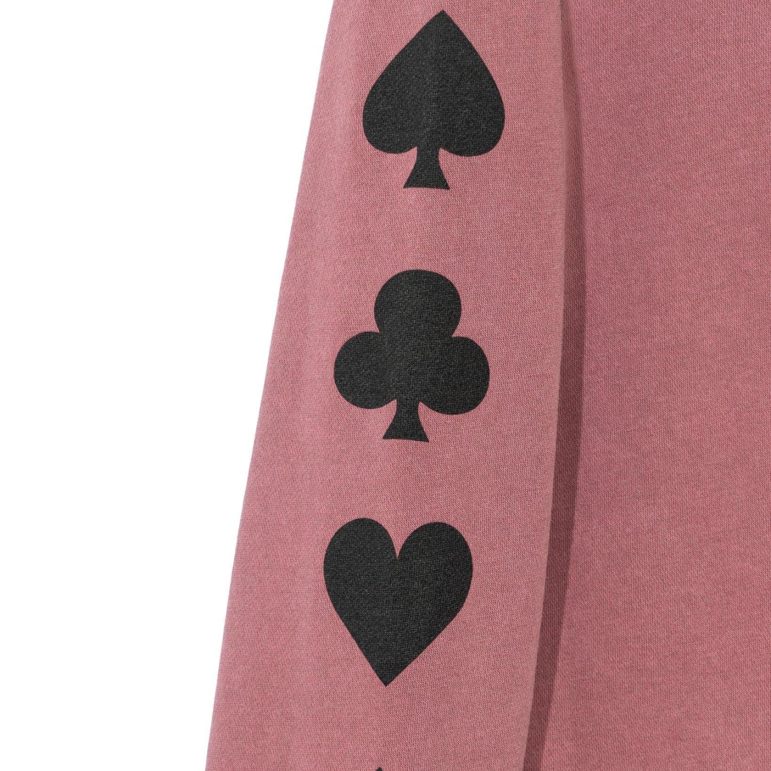 Mauve crewneck sweatshirt sleeve with black spade, club, and heart card suit symbols