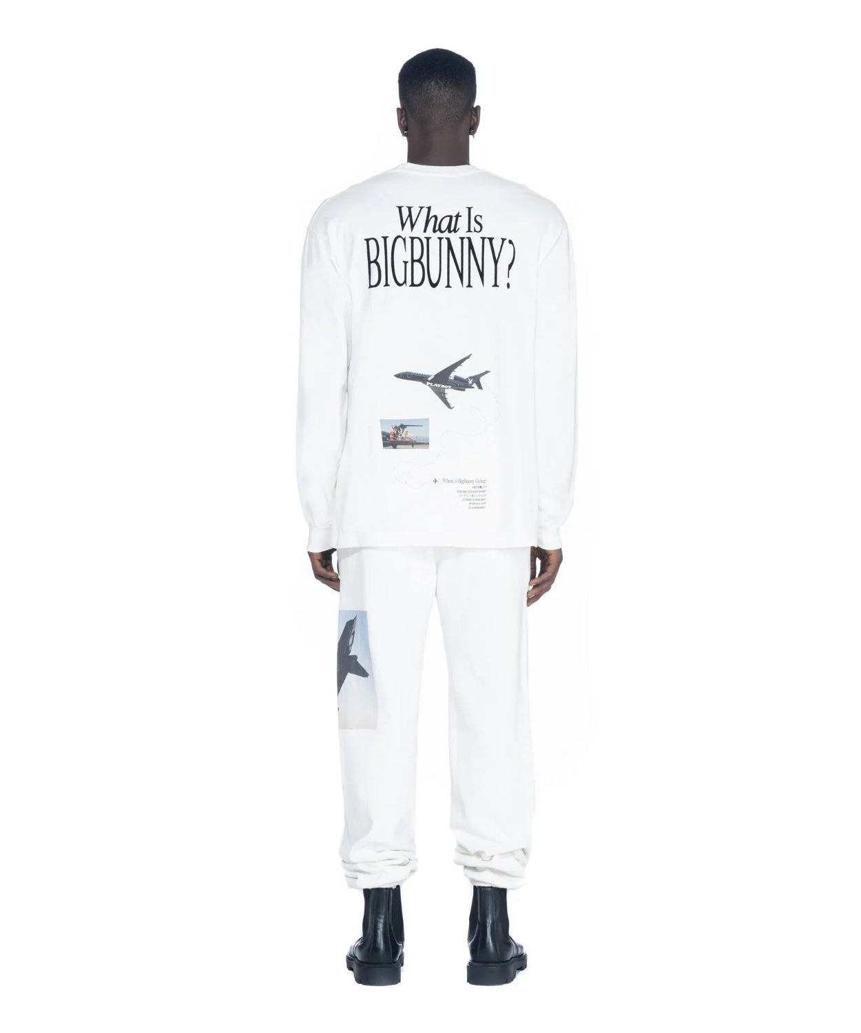 Man wearing white long sleeve t-shirt with airplane and 'What Is Big Bunny?' text on back