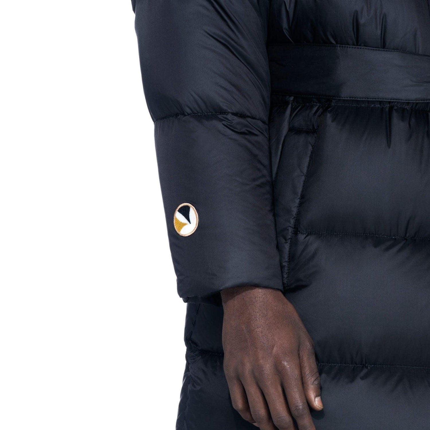 Closeup of black belted long puffer jacket sleeve with logo patch detail