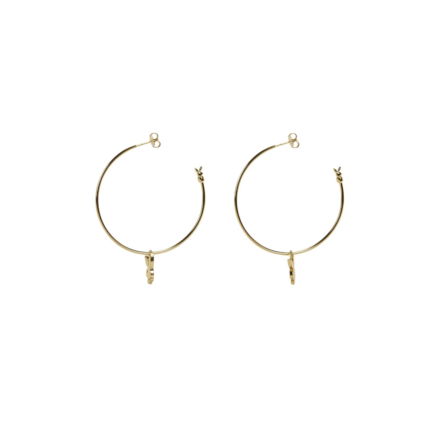 Pair of gold hoop earrings with small bunny charm detail on white background