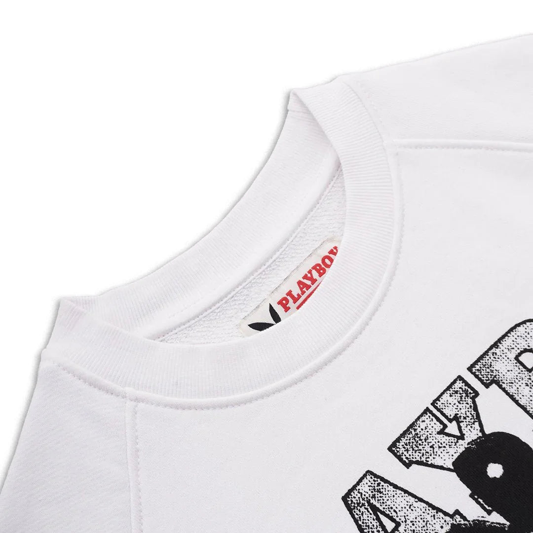 Close-up of white sweatshirt with bold black graphic text and visible PLAYBOY label at neckline