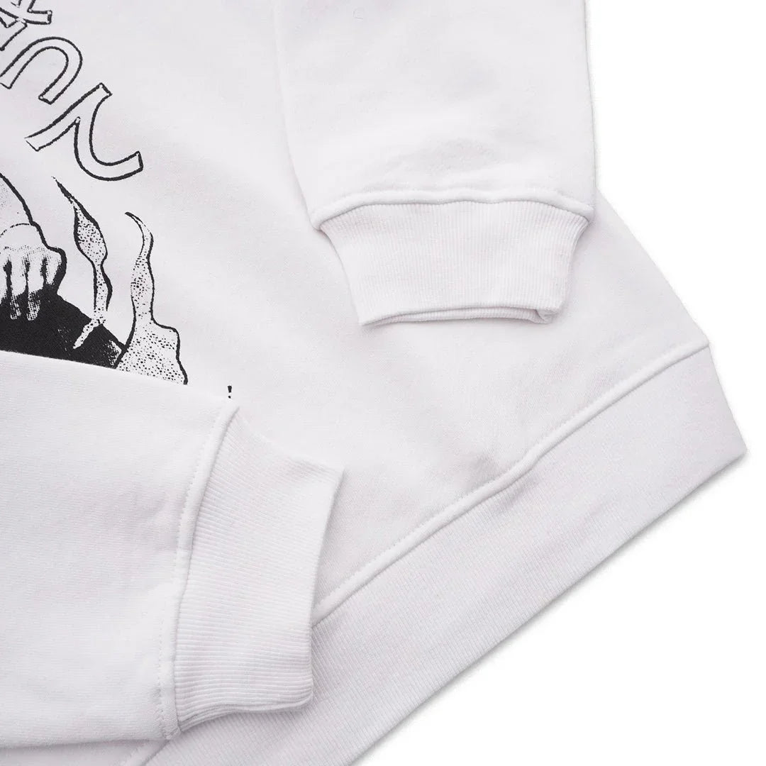 White sweatshirt with black graphic design and ribbed cuffs, close-up view