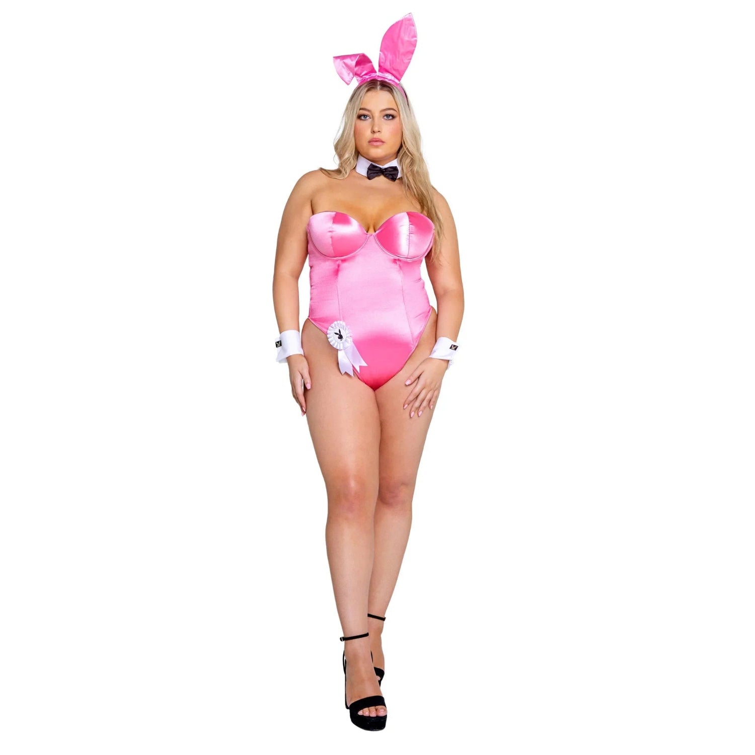 Woman in pink bunny costume with matching ears, bowtie, cuffs, and high heels on white background