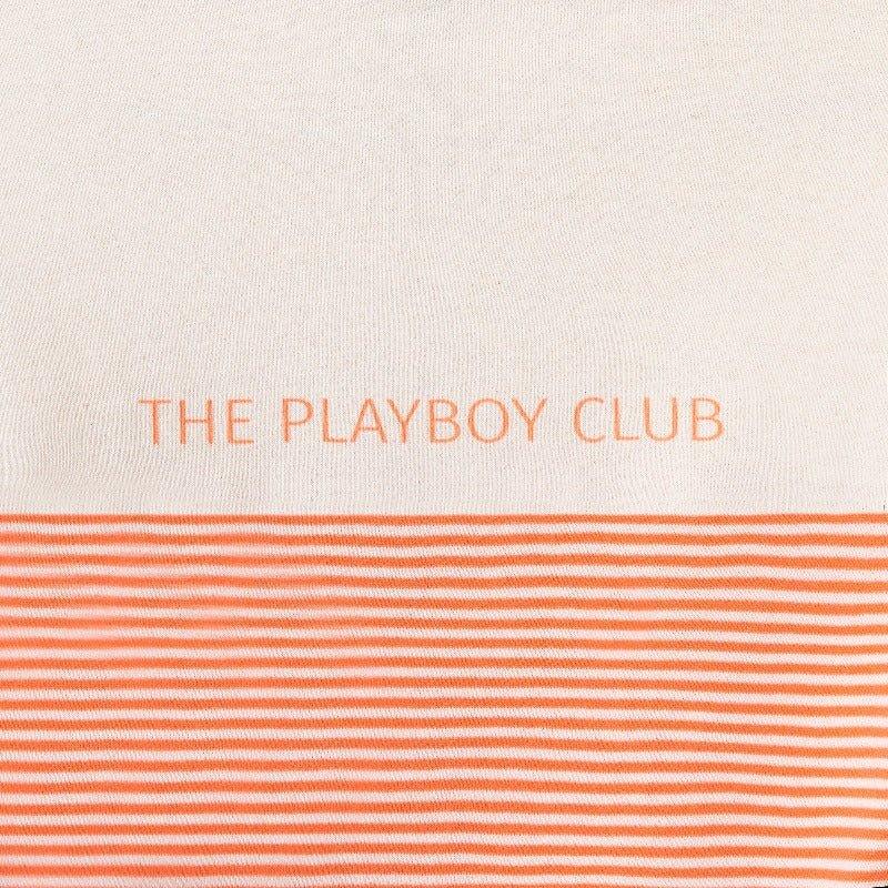 Cream and orange striped fabric with 'The Playboy Club' text on apparel.