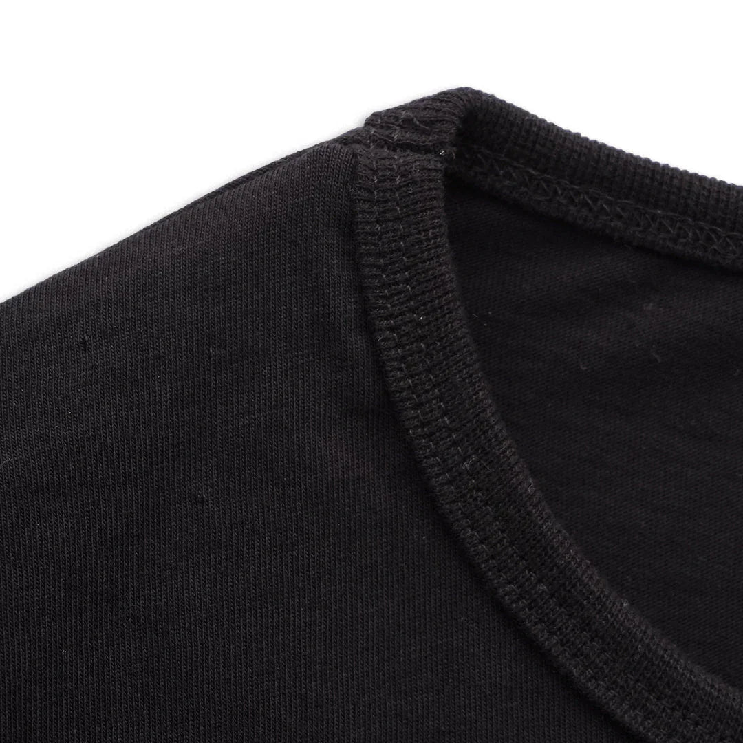 Closeup of black boxy t-shirt collar and stitching detail