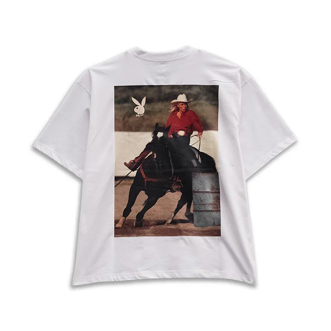 White boxy tee with graphic of cowgirl riding a horse and logo on the back
