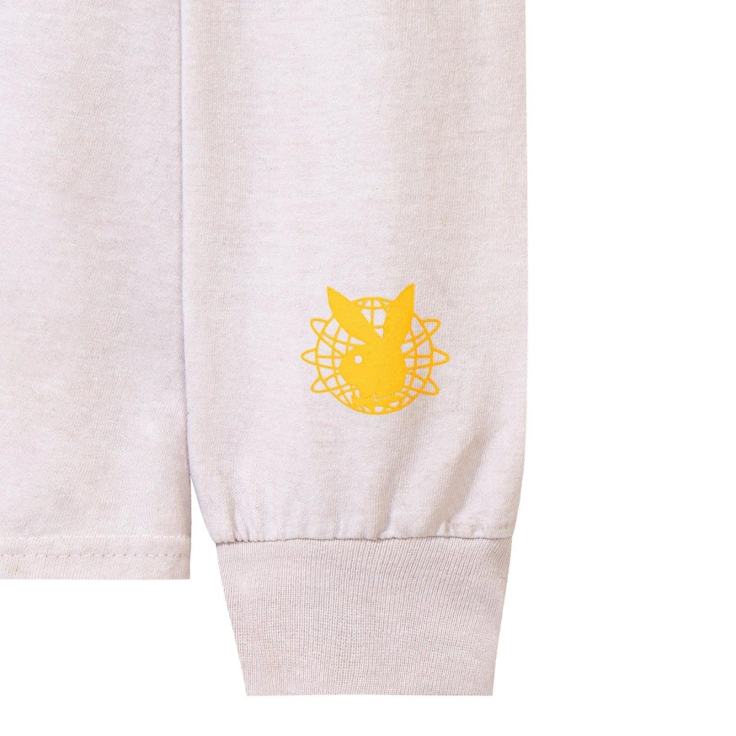 Light long sleeve shirt with yellow graphic logo on cuff, close-up view