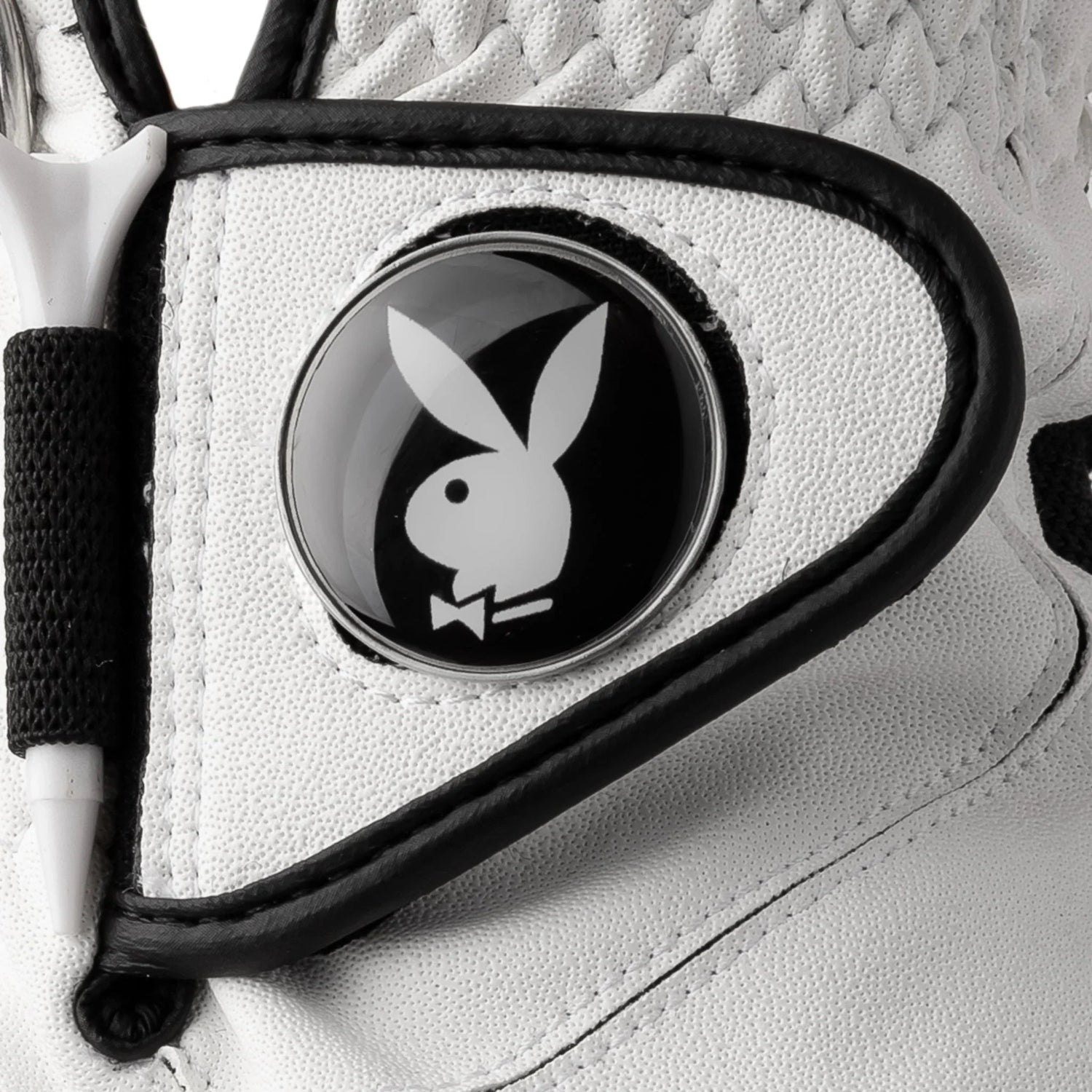 Close-up of white golf glove with black trim and bunny logo button detail