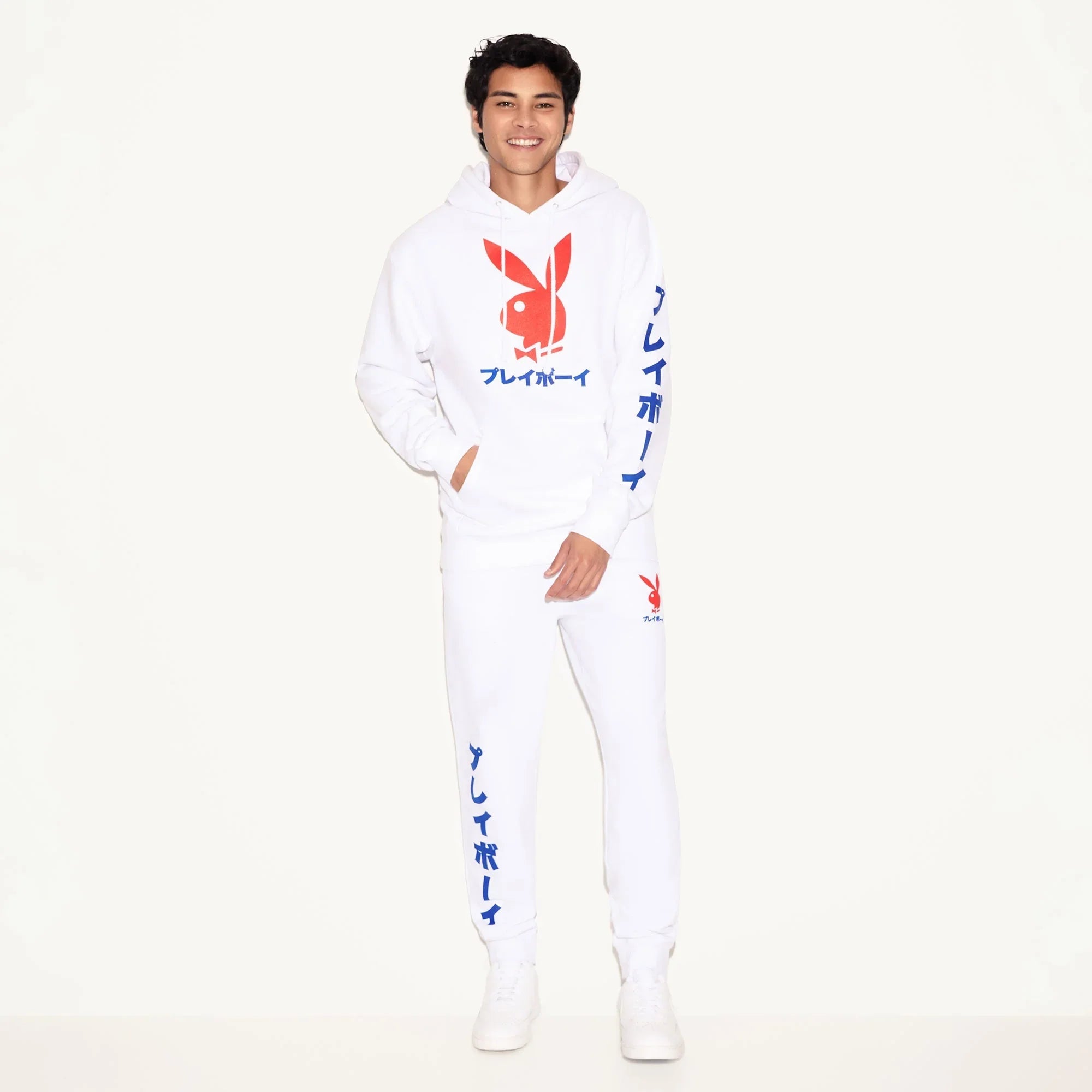 Man wearing white hoodie and joggers with red rabbit head graphic and Japanese text accents