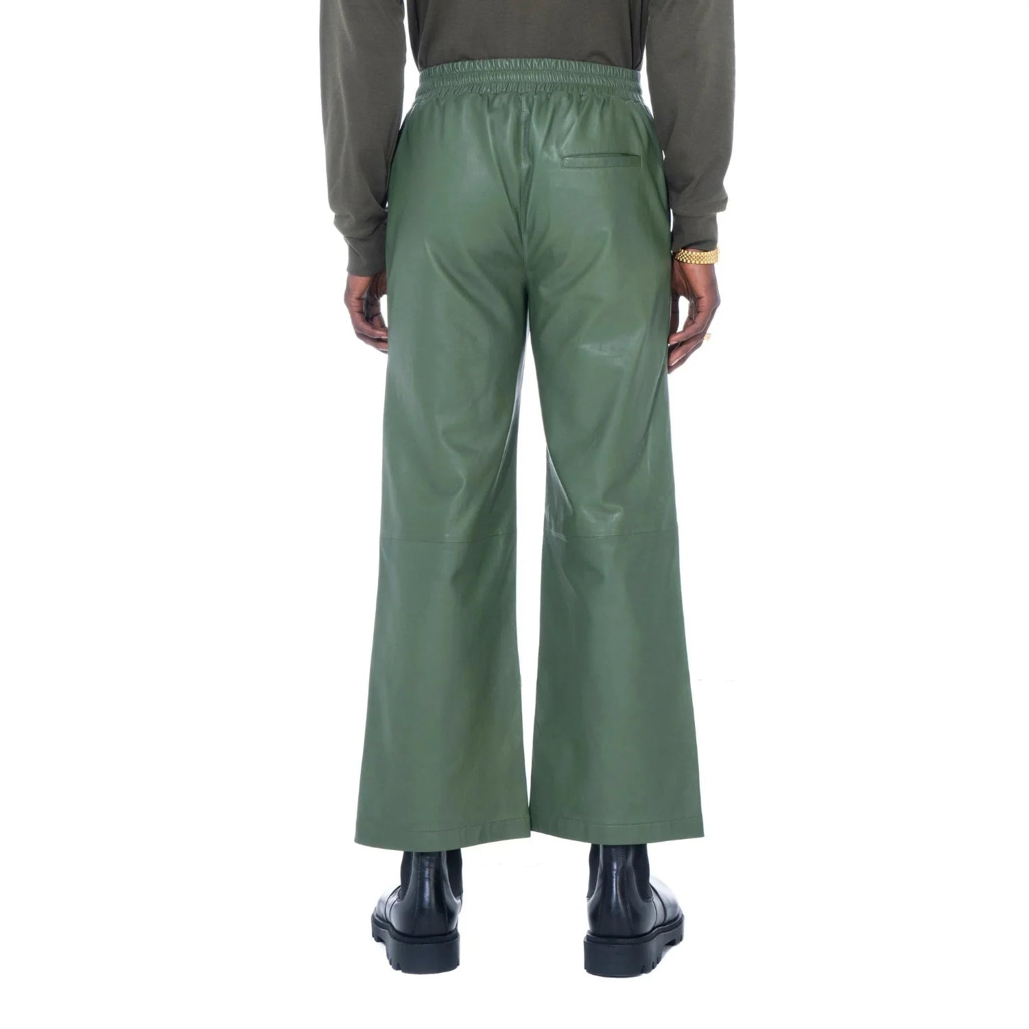 Back view of green faux leather flare pants with elastic waist and single back pocket