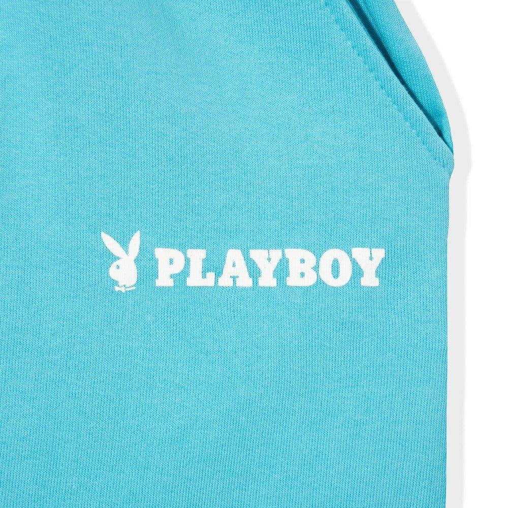 Light blue fabric with bold white PLAYBOY text and bunny logo, close-up apparel detail