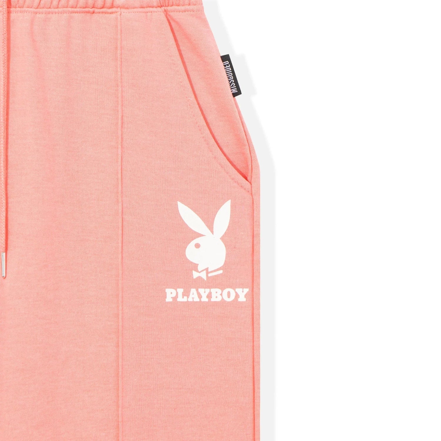Pink sweatpants with white bunny logo and text, side pocket visible
