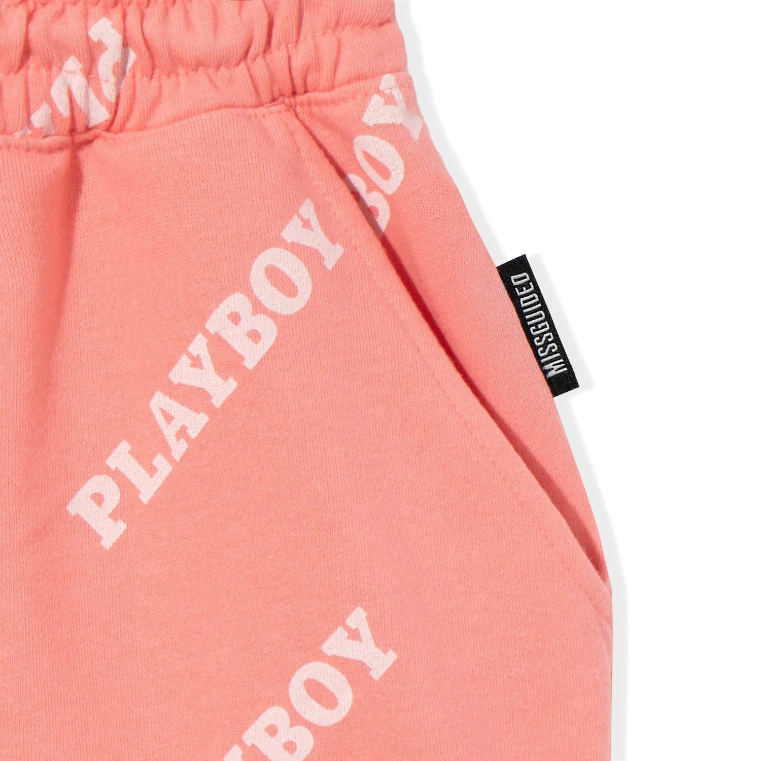 Pink shorts with white PLAYBOY logo print and Missguided tag, elastic waistband, front pocket