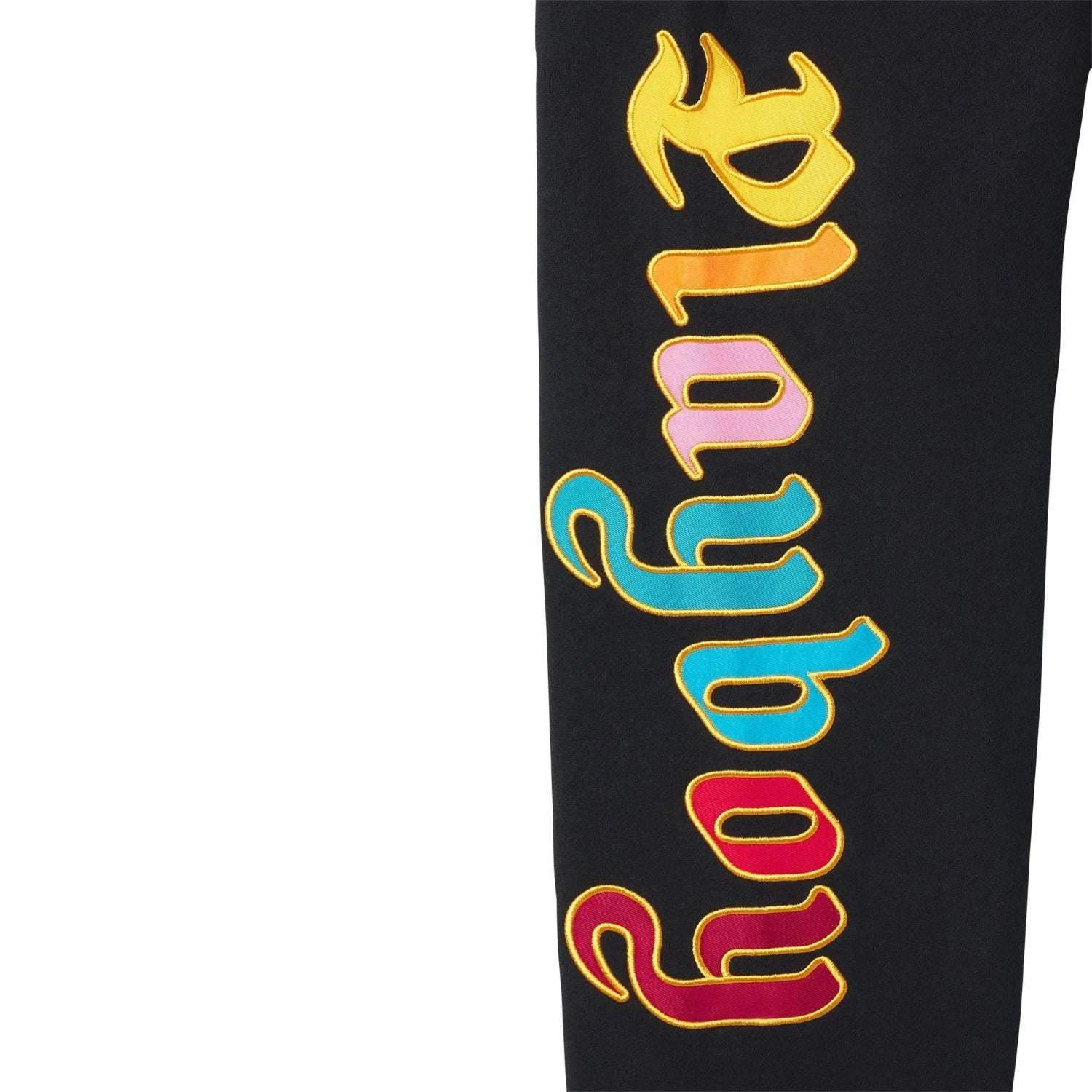 Black sweatpants leg with colorful embroidered retro style text on side