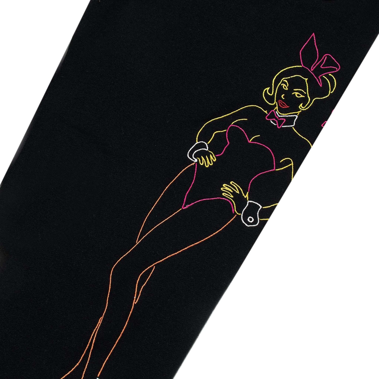 Black sweatpants with colorful embroidered outline of a woman in bunny costume