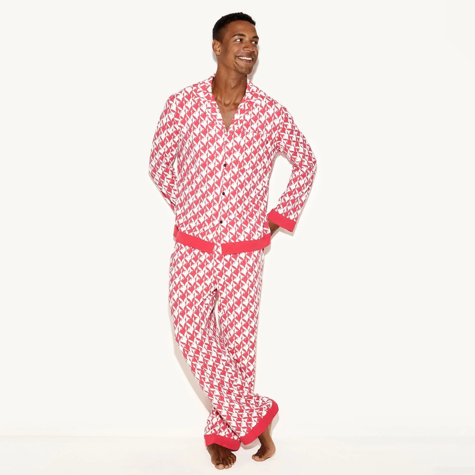 Man wearing red and white patterned classic men's pajama set with bunny motifs