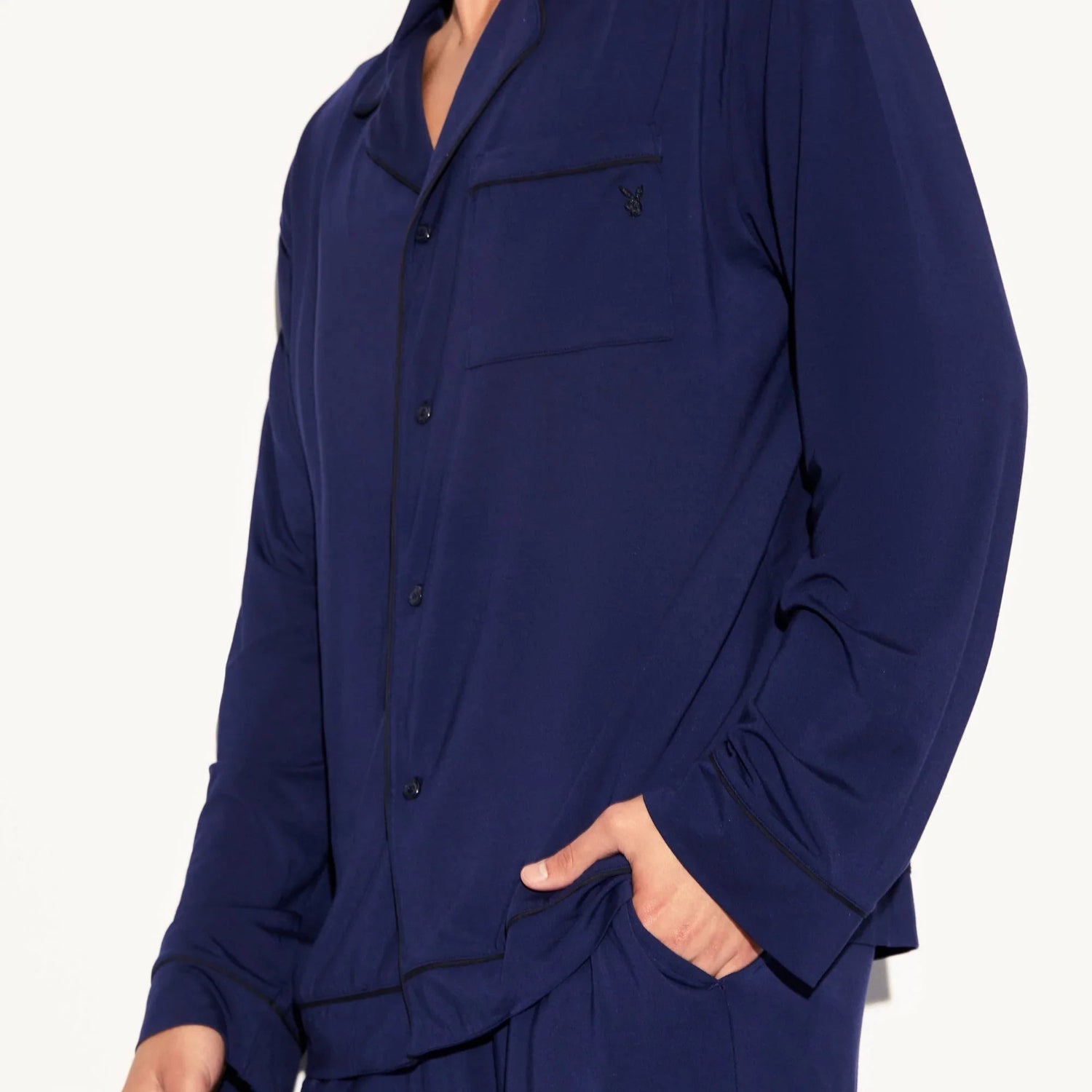 Man wearing navy blue classic men's sleep set with chest pocket and button-up shirt