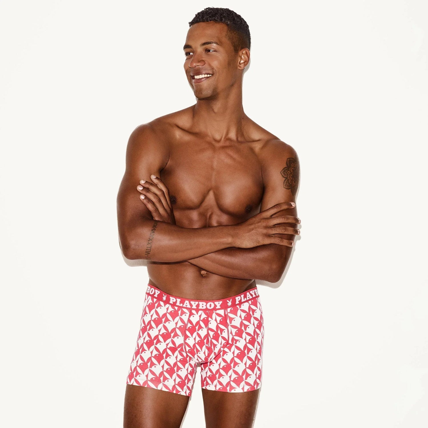 Male model wearing red and white patterned men's boxer briefs with visible branded waistband