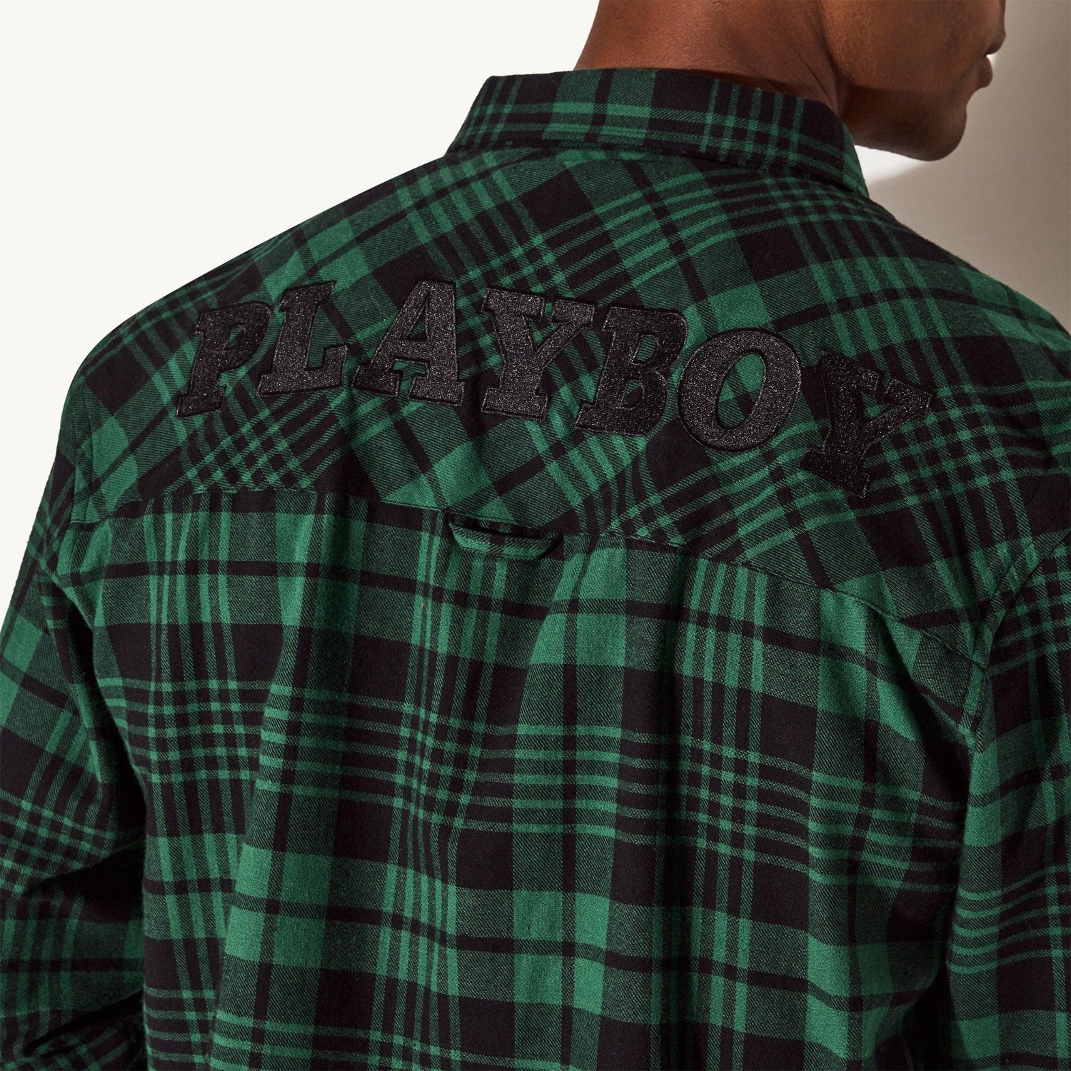 Green and black plaid men's flannel shirt with embroidered PLAYBOY lettering on back
