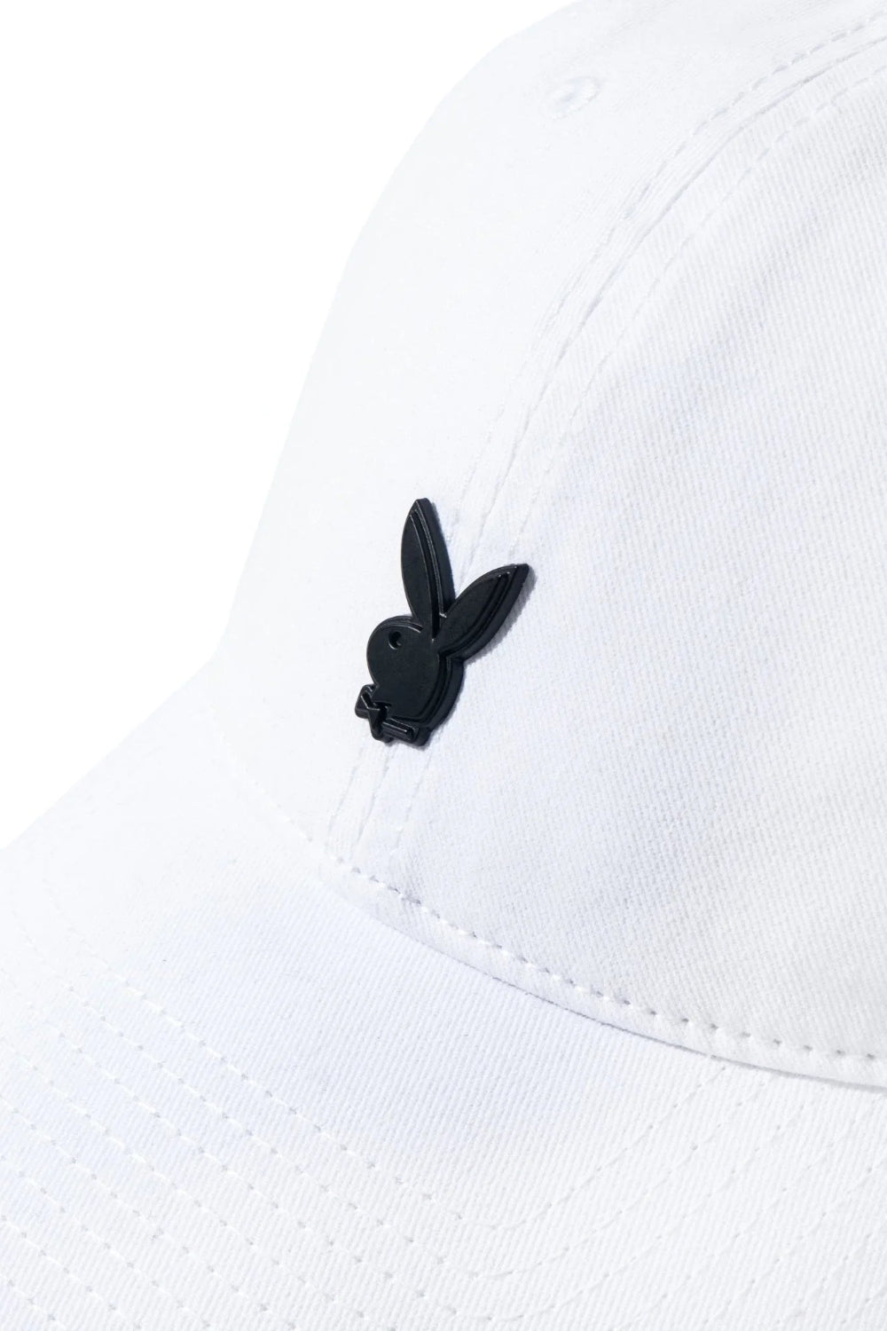 White dad hat with black metal rabbit head pin on front