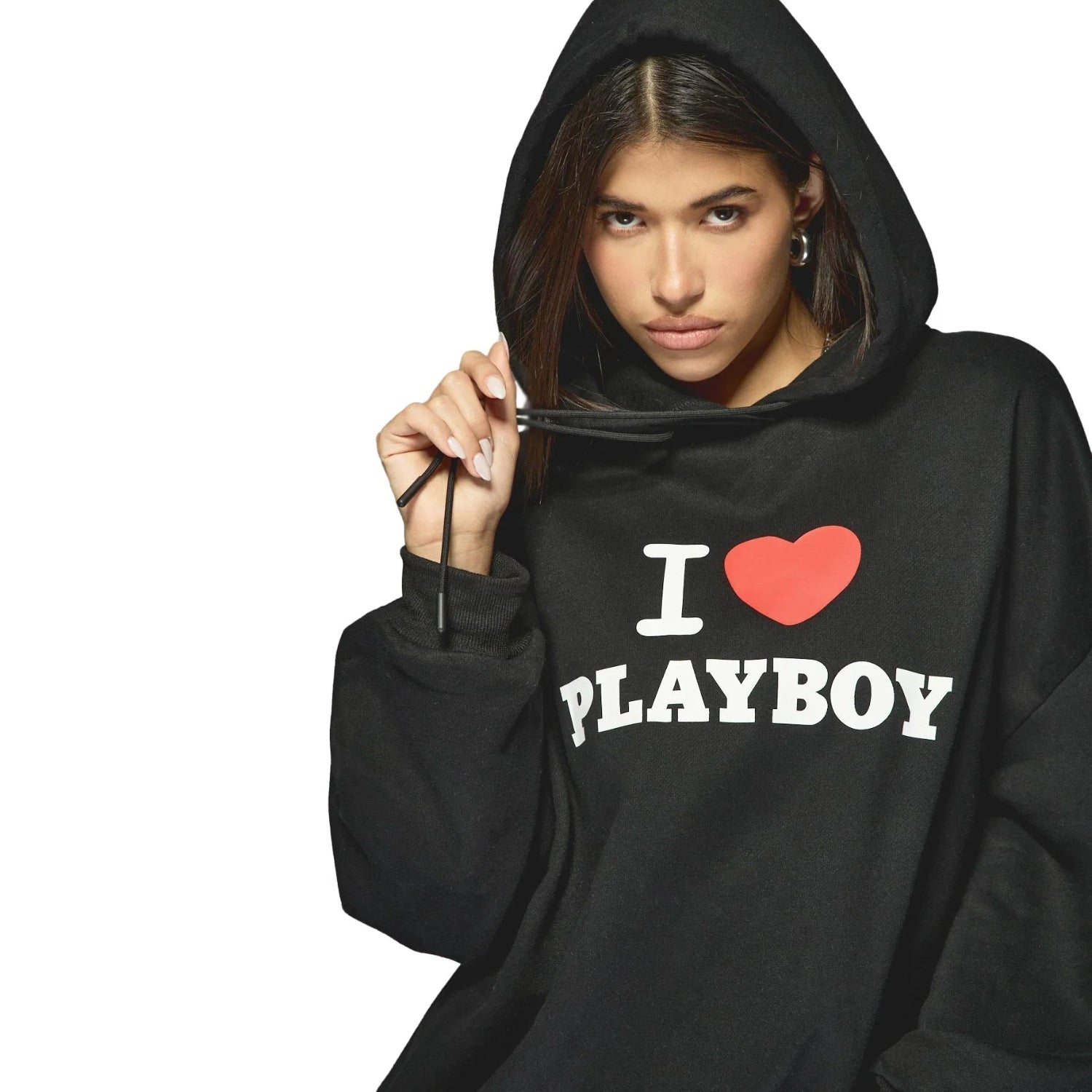 Woman wearing black hoodie with 'I heart Playboy' text on front, hood up, white background
