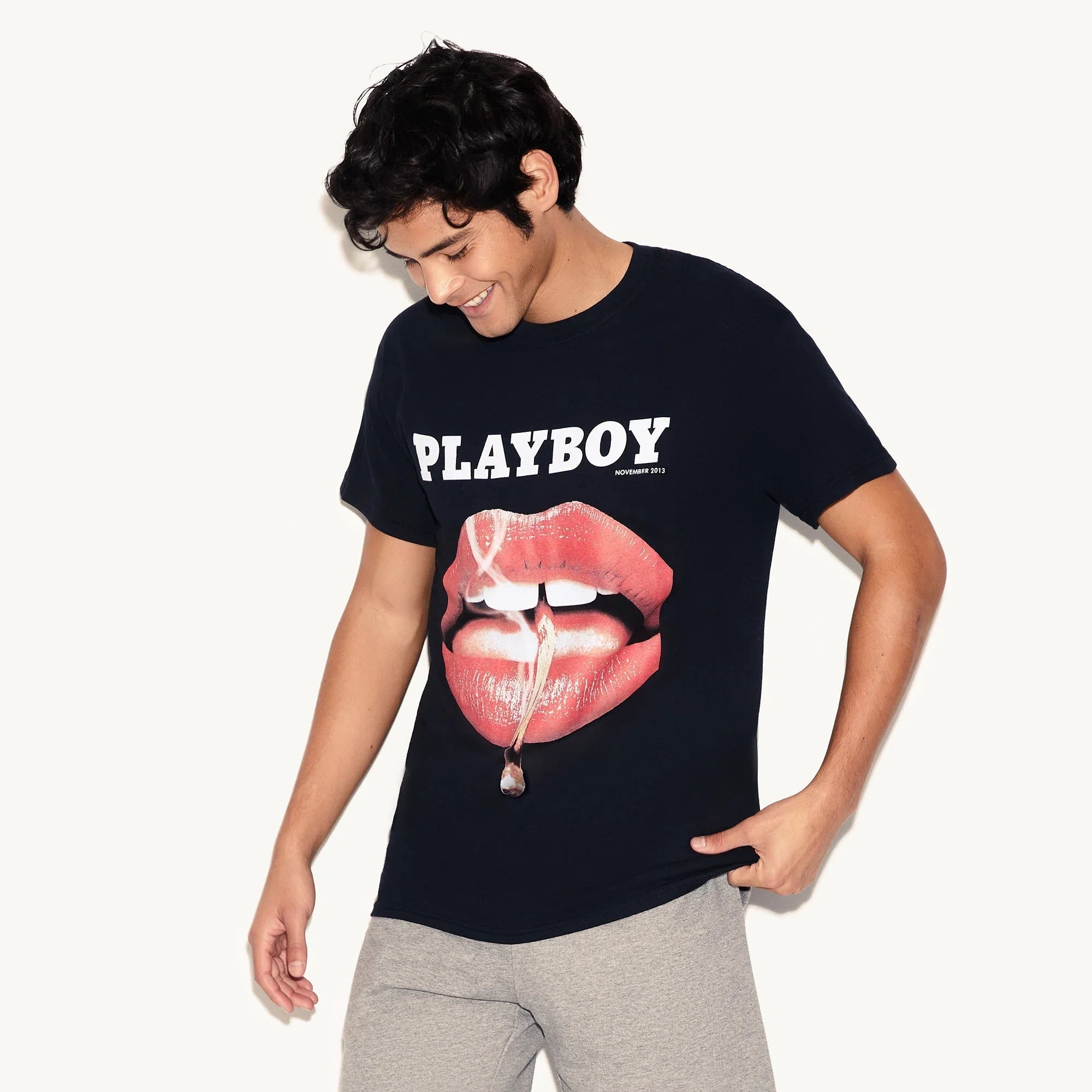Man wearing black t-shirt with glossy lips and PLAYBOY November 2013 graphic print