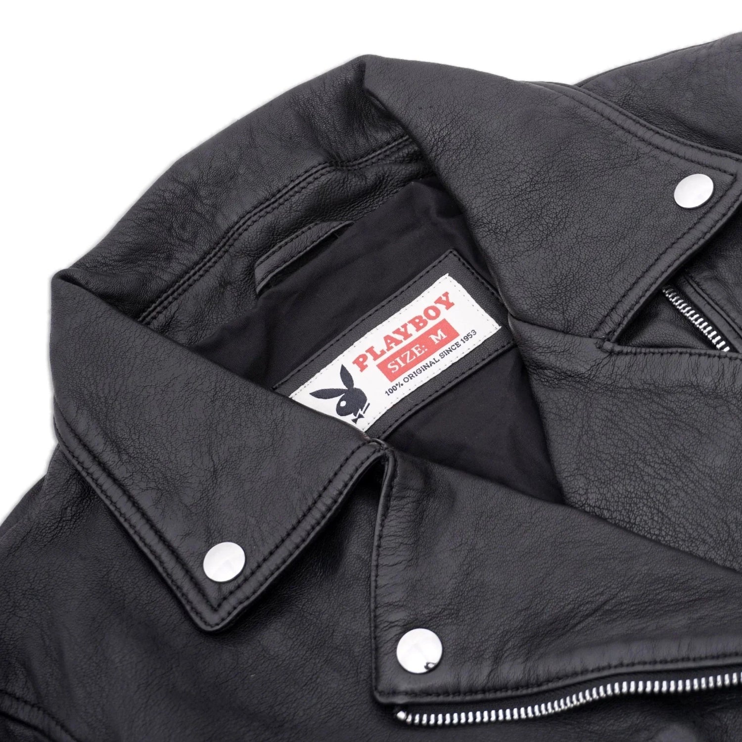 Close-up of black women's leather jacket with metal buttons and visible label inside collar
