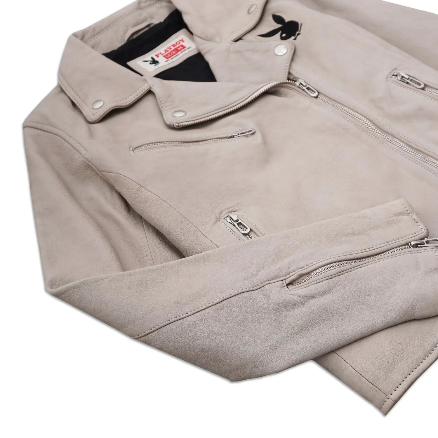 Beige women’s leather jacket with zippers and black bunny logo on chest